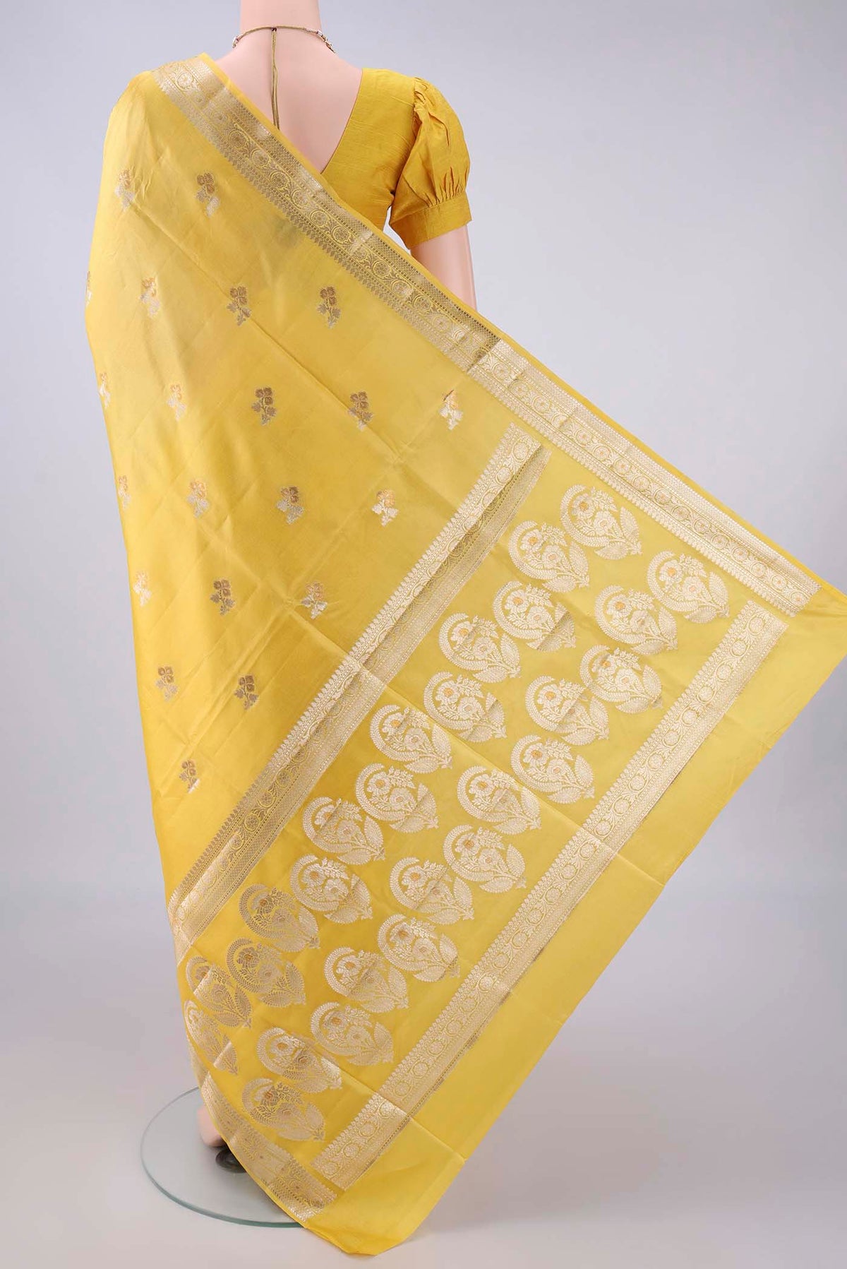 Flat view of Pure Silk Yellow Banarasi Raw Saree with Zari Butta on the body and Zari Border. 