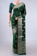 Pure Silk Bottle Green Banarasi Raw Saree with Zari Butta on the body and Zari Border.  displayed on a mannequin