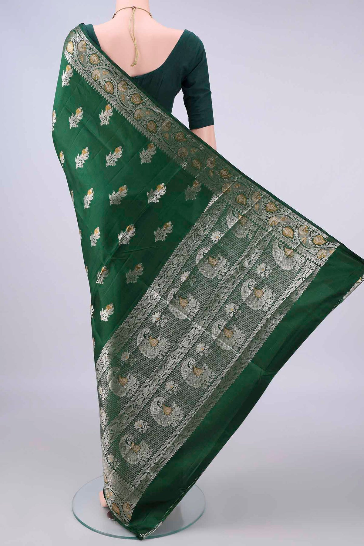 Flat view of Pure Silk Bottle Green Banarasi Raw Saree with Zari Butta on the body and Zari Border. 