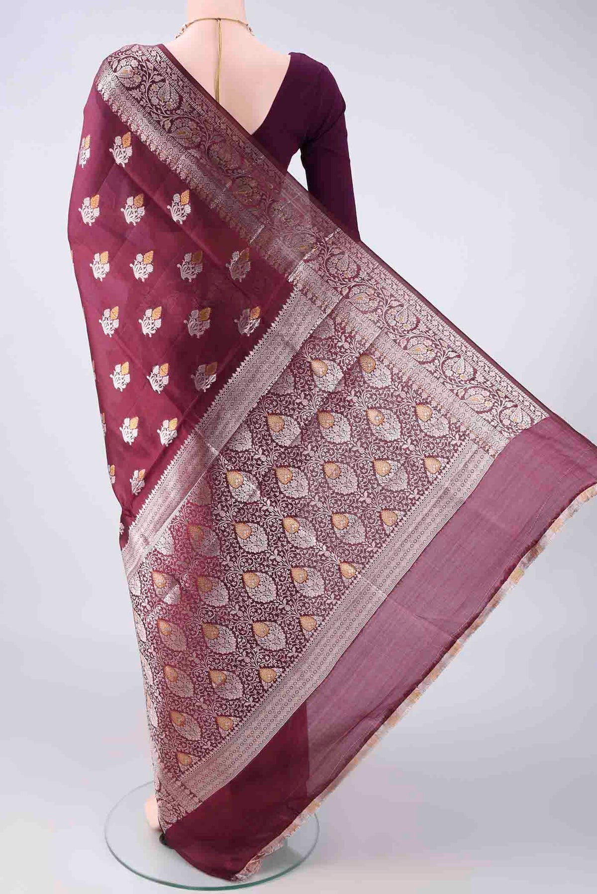 Flat view of Pure Silk Burgundy Banarasi Raw Saree with Zari Butta on the body and Zari Border. 