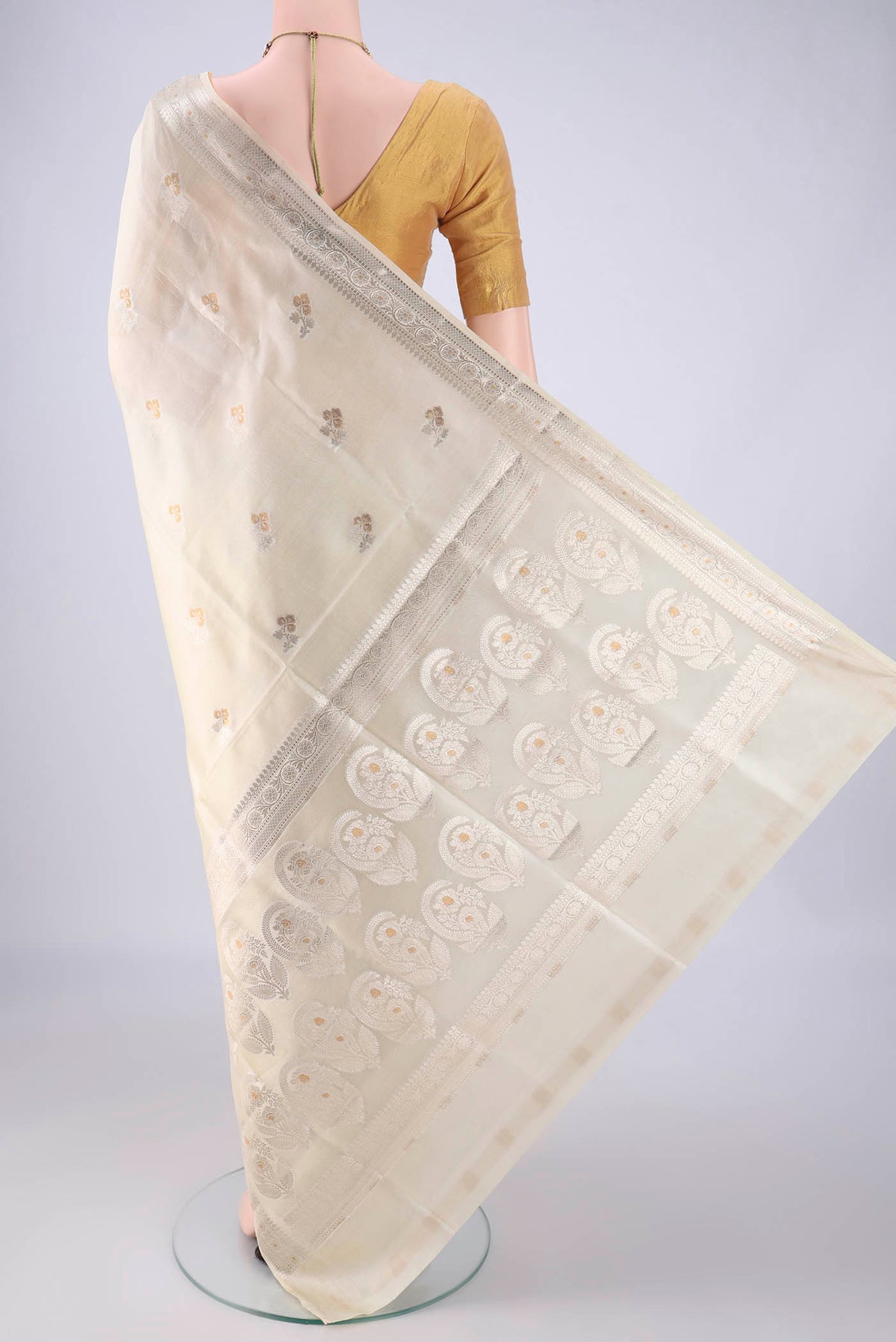 Flat view of Cream Banarasi Raw Silk Saree with Zari Butta on the body and Zari Border. 
