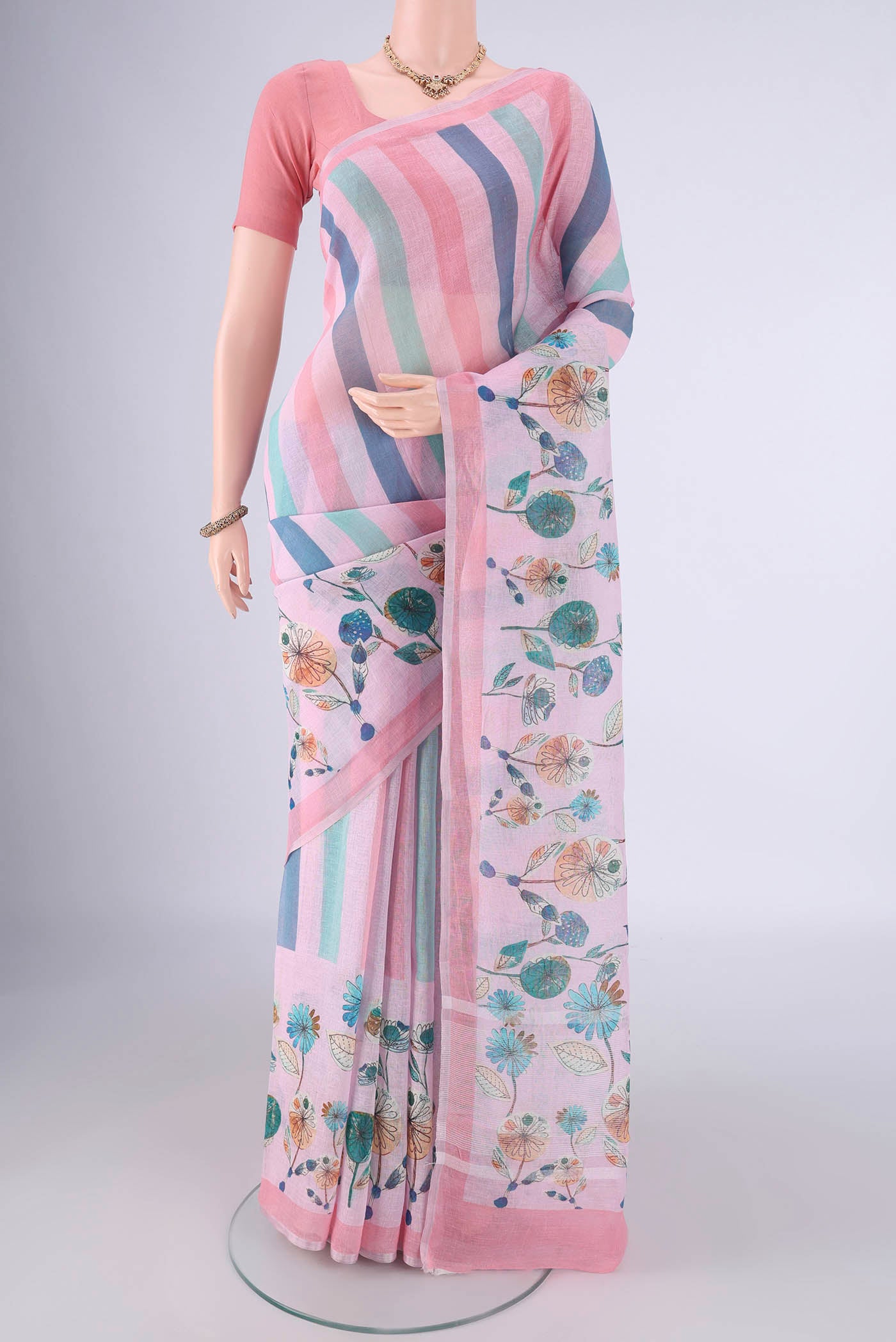 Multi Color Linen Saree with Geometric Print on the body and Zari Border.  displayed on a mannequin