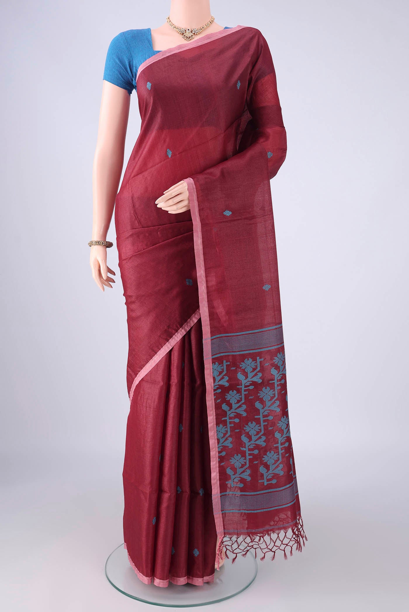 Maroon Tussar Silk Saree with Thread Butta on the body and Plain Border.  displayed on a mannequin