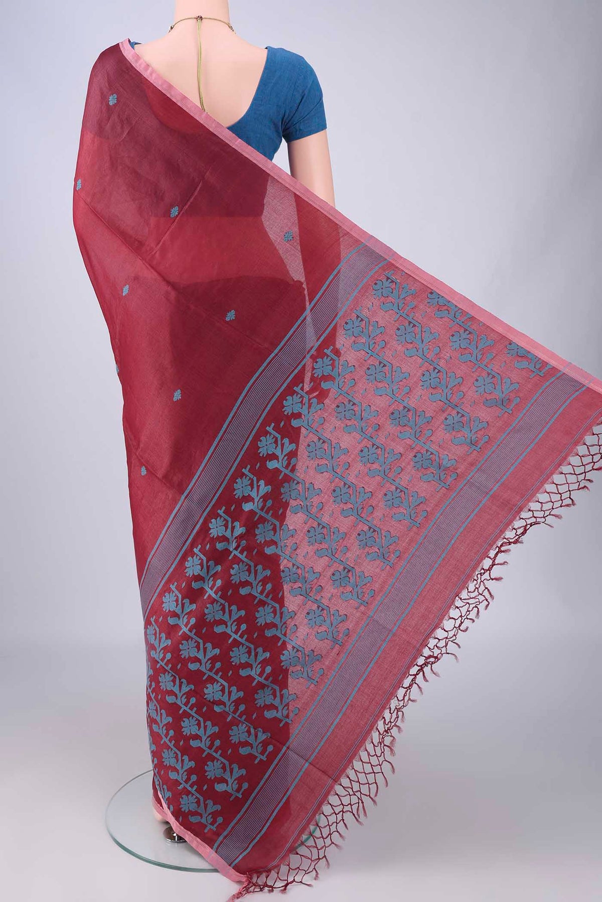 Flat view of Maroon Tussar Silk Saree with Thread Butta on the body and Plain Border. 