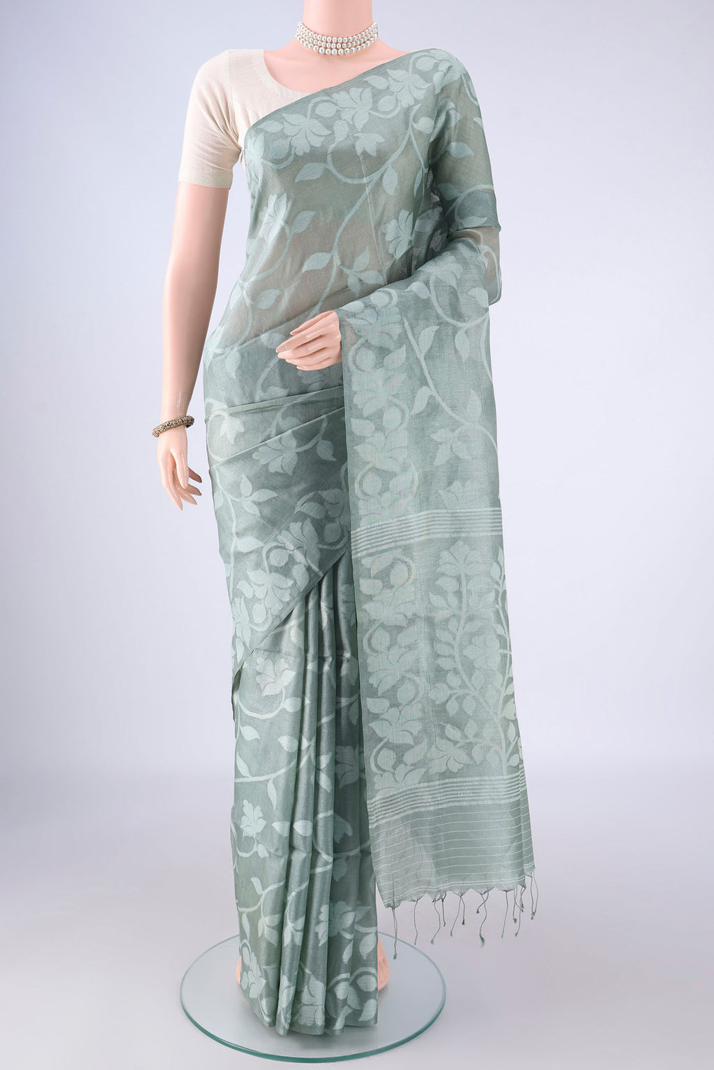 Sage Green Tussar Silk Saree with Jamdani on the body and Thread Border.  displayed on a mannequin