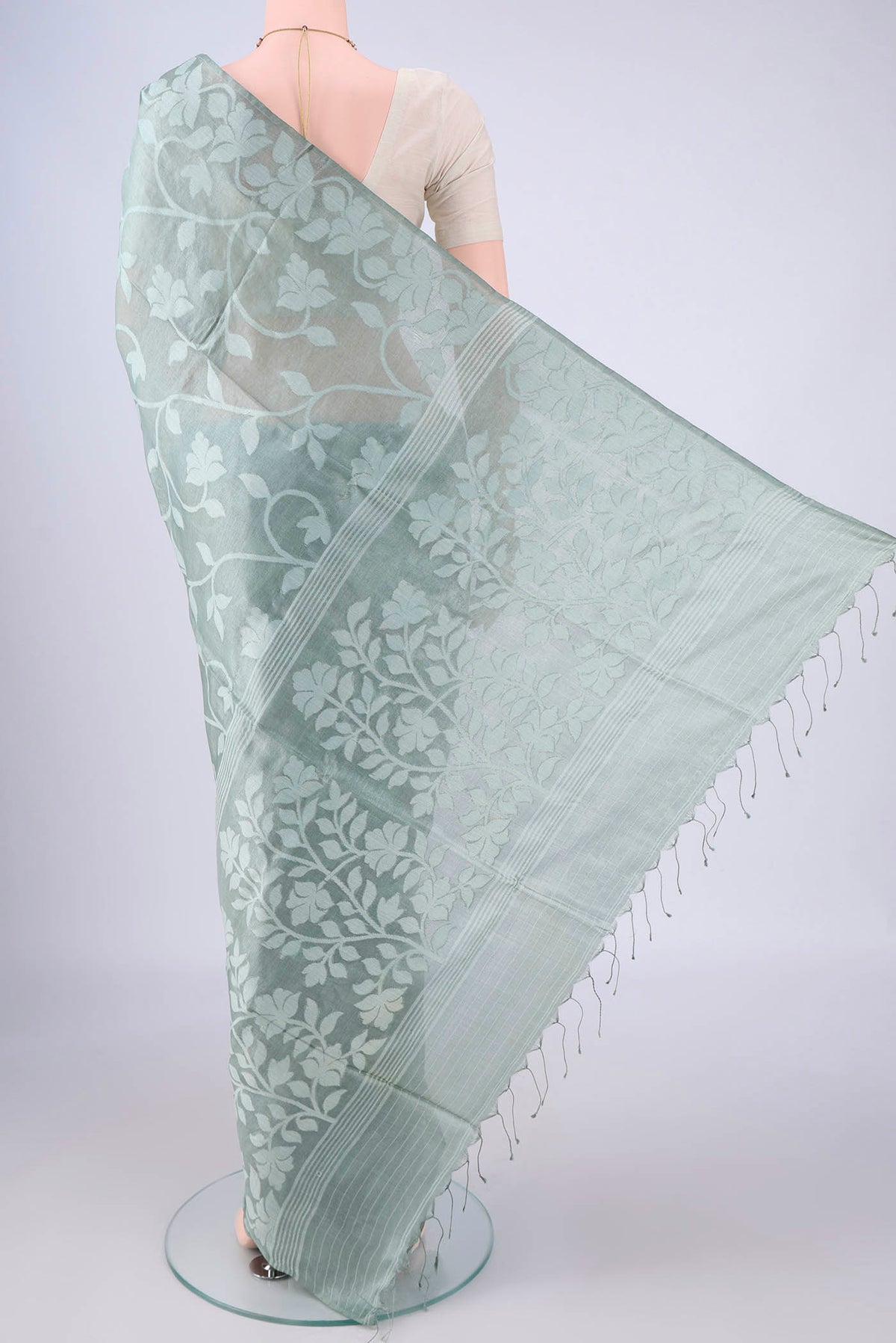 Flat view of Sage Green Tussar Silk Saree with Jamdani on the body and Thread Border. 