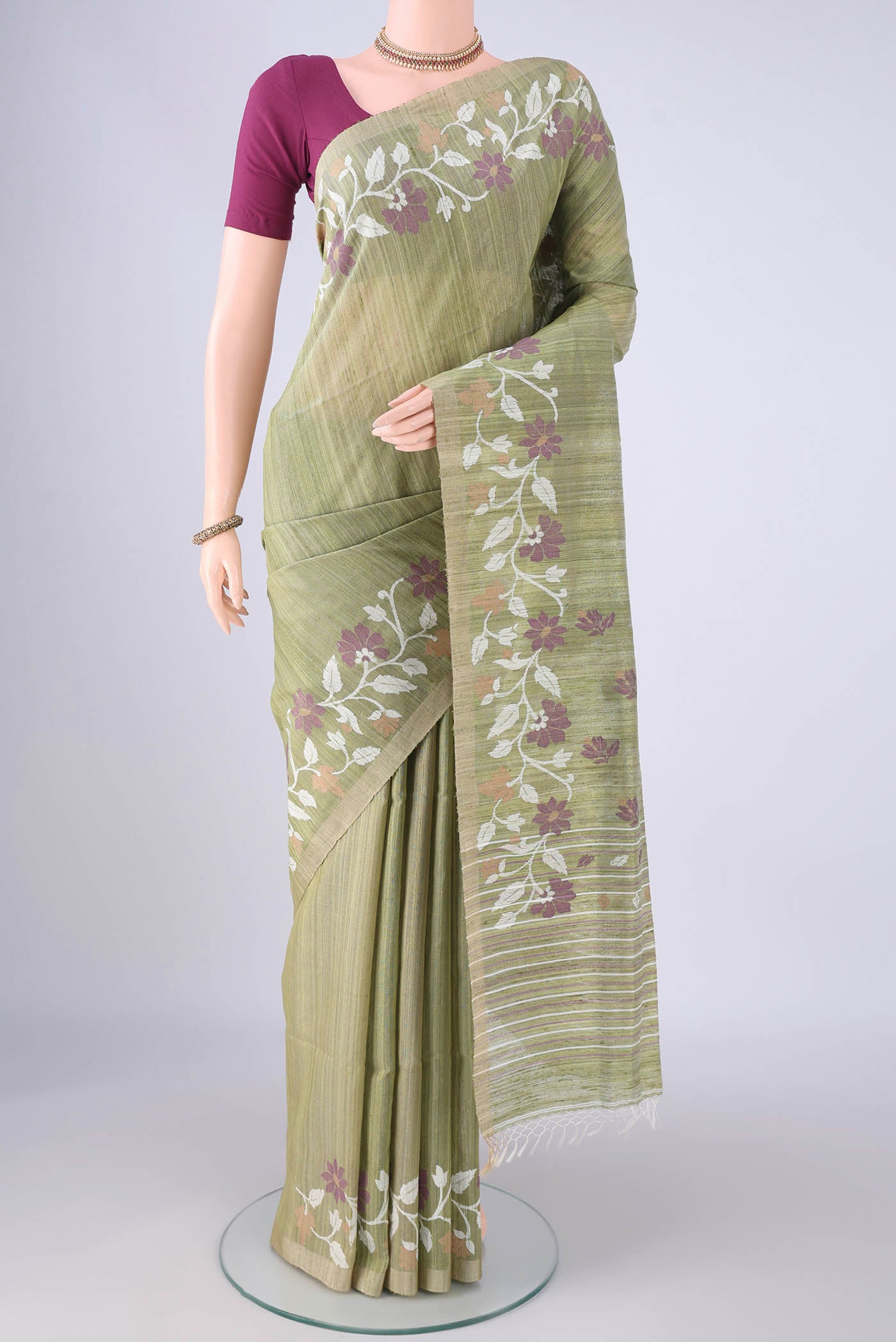 Light Green Jute Silk Saree with Plain Body and Thread Border.  displayed on a mannequin