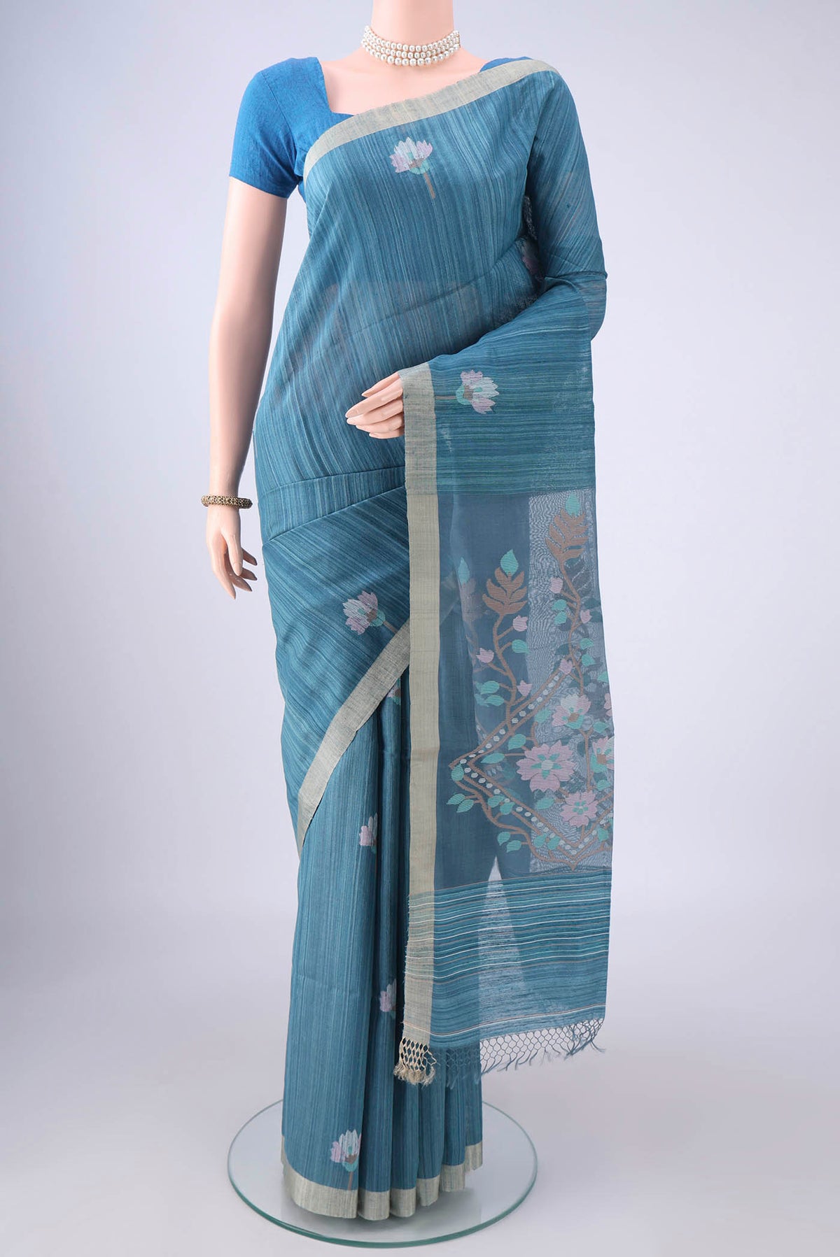 Blue Jute Silk Saree with Jamdani on the body and Thread Border.  displayed on a mannequin