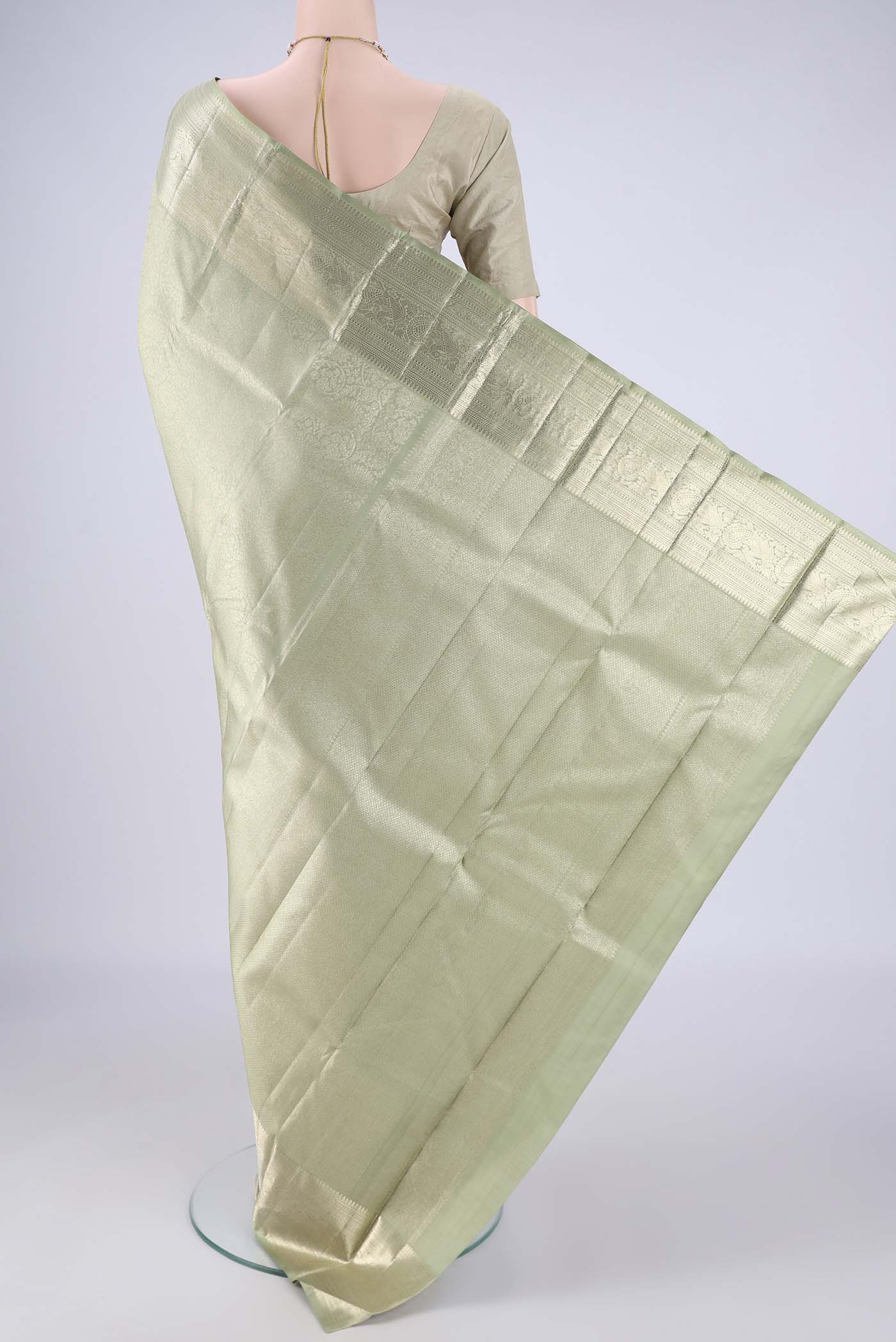 Flat view of Sage Green Kanchipuram Silk Saree with Zari Brocade on the body and Zari Border. 