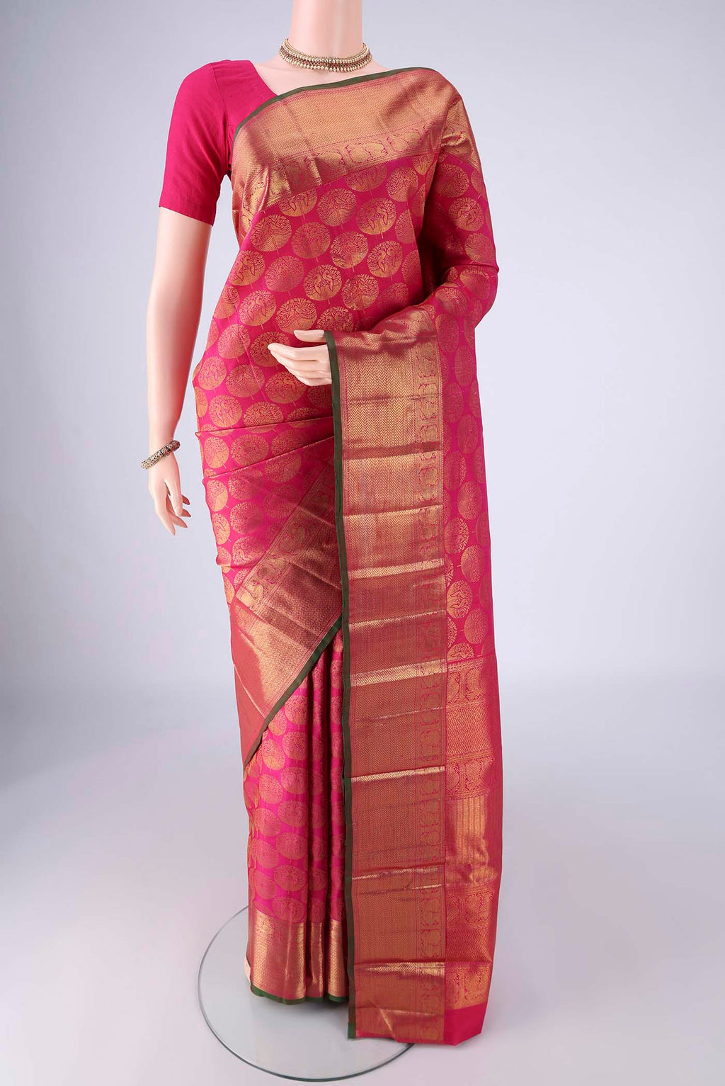 Rani Pink Kanchipuram Silk Saree with Zari Brocade on the body and Zari Border.  displayed on a mannequin