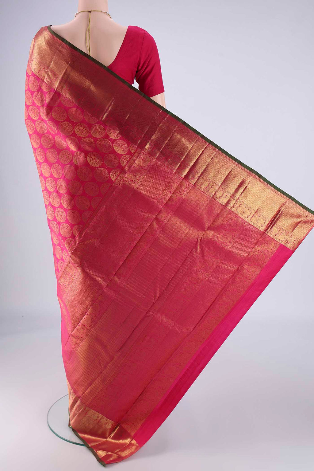 Flat view of Rani Pink Kanchipuram Silk Saree with Zari Brocade on the body and Zari Border. 
