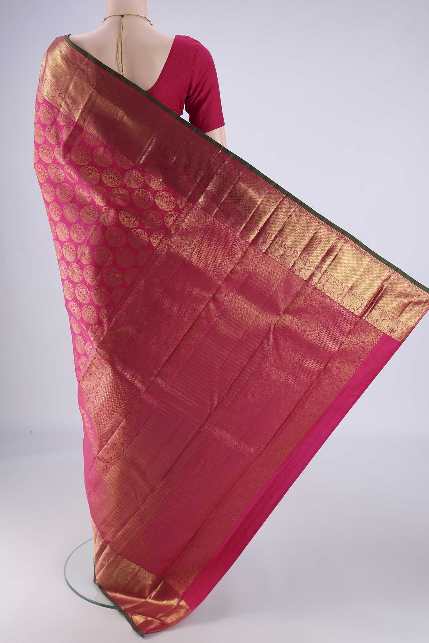 Flat view of Rani Pink Kanchipuram Silk Saree with Zari Brocade on the body and Zari Border. 