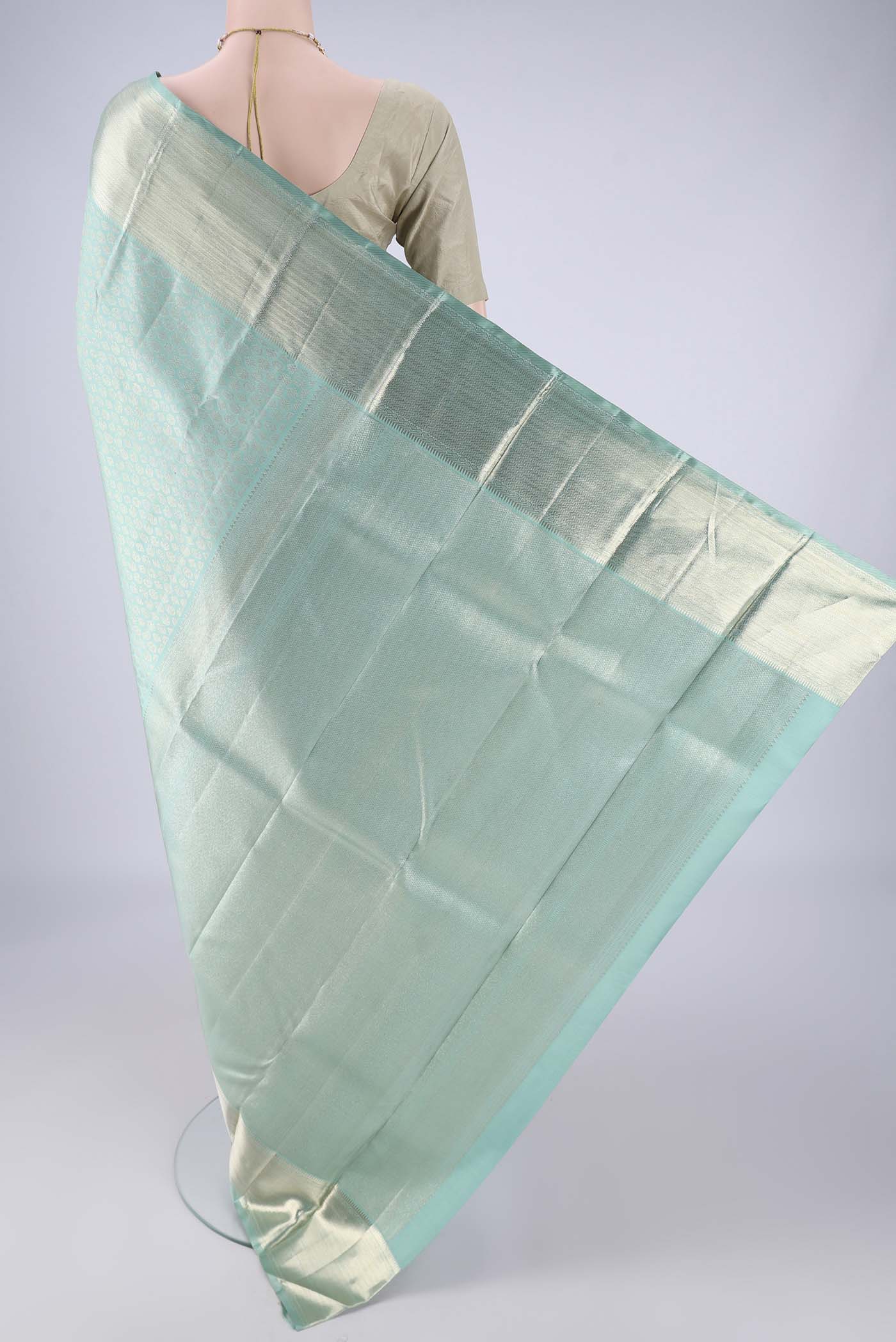 Flat view of Light Blue Kanchipuram Silk Saree with Zari Brocade on the body and Zari Border. 