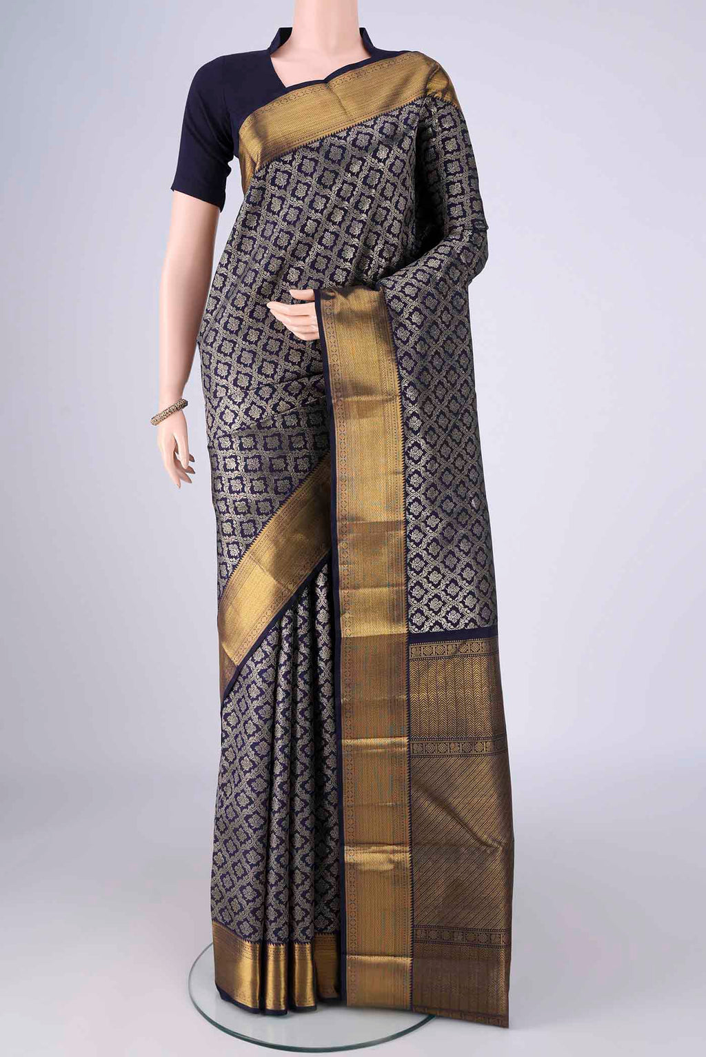 Navy Blue Kanchipuram Silk Saree with Zari Brocade on the body and Zari Border.  displayed on a mannequin
