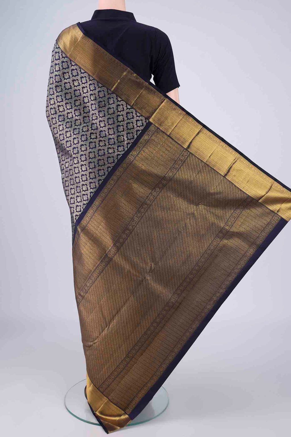 Flat view of Navy Blue Kanchipuram Silk Saree with Zari Brocade on the body and Zari Border. 