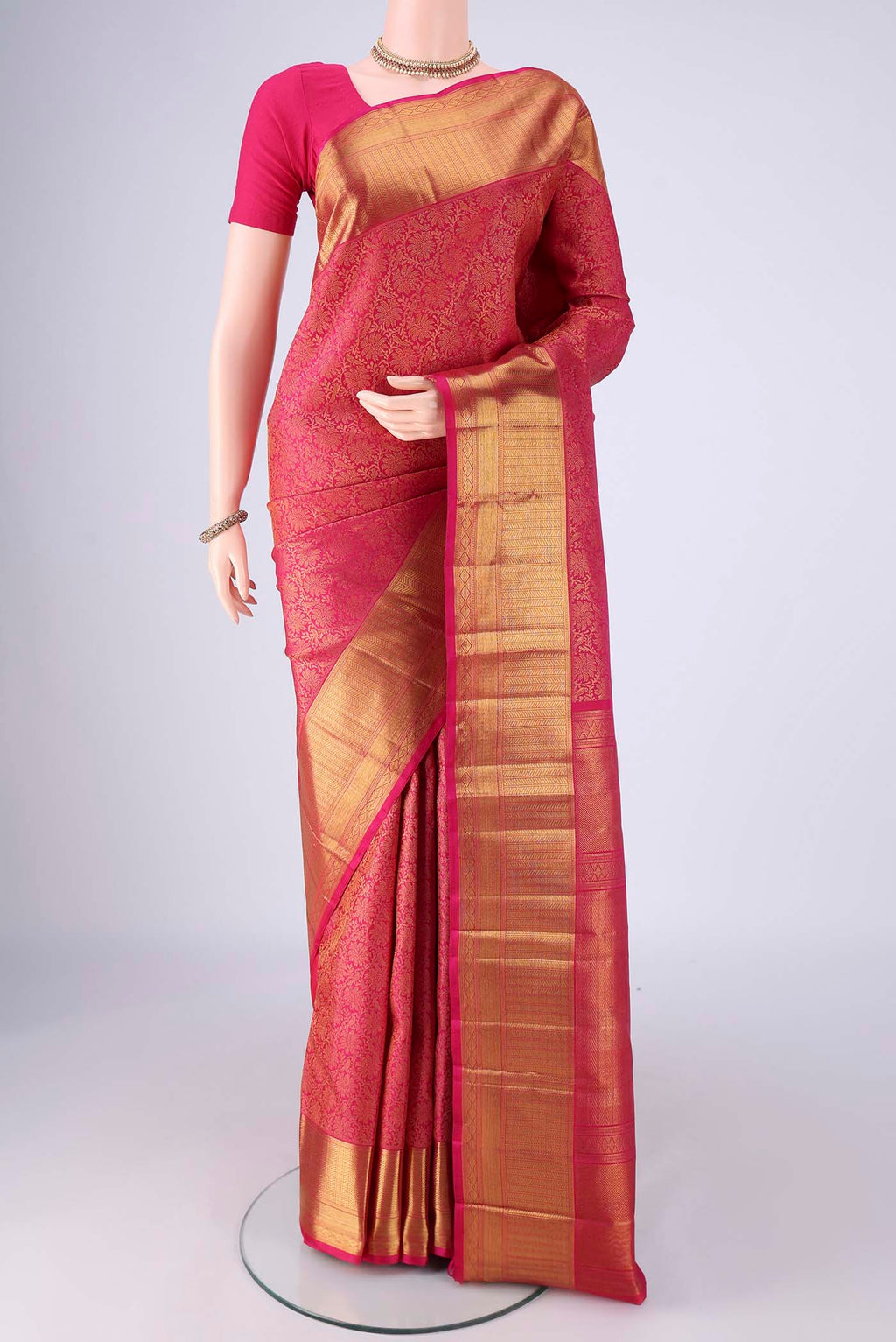 Pink Kanchipuram Silk Saree with Zari Brocade on the body and Zari Border.  displayed on a mannequin
