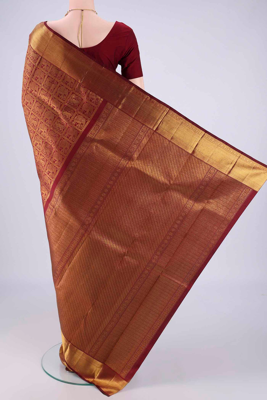 Flat view of Maroon Kanchipuram Silk Saree with Zari Brocade on the body and Zari Border. 