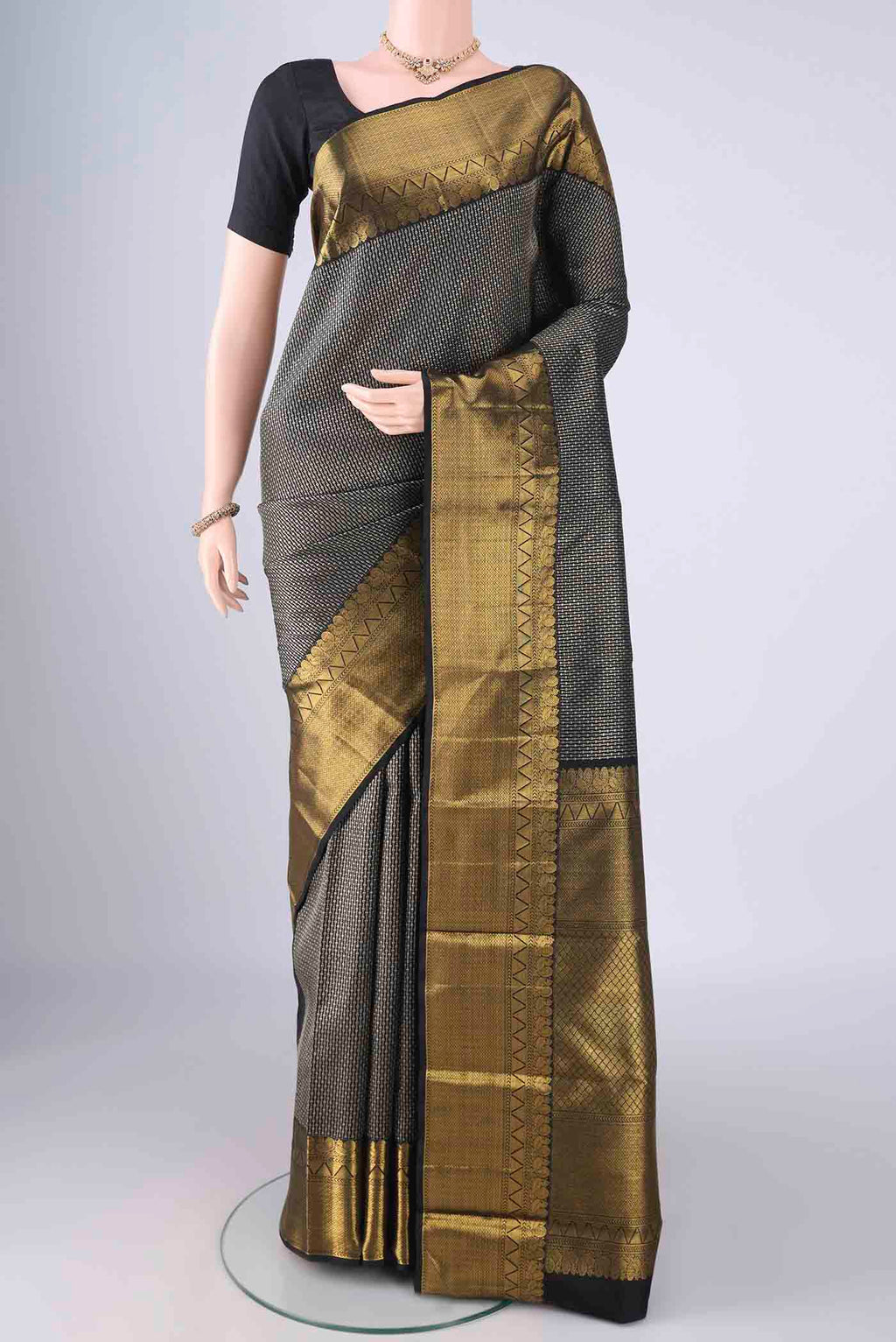 Black Kanchipuram Silk Saree with Zari Brocade on the body and Zari Border.  displayed on a mannequin