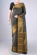 Black Kanchipuram Silk Saree with Zari Brocade on the body and Zari Border.  displayed on a mannequin