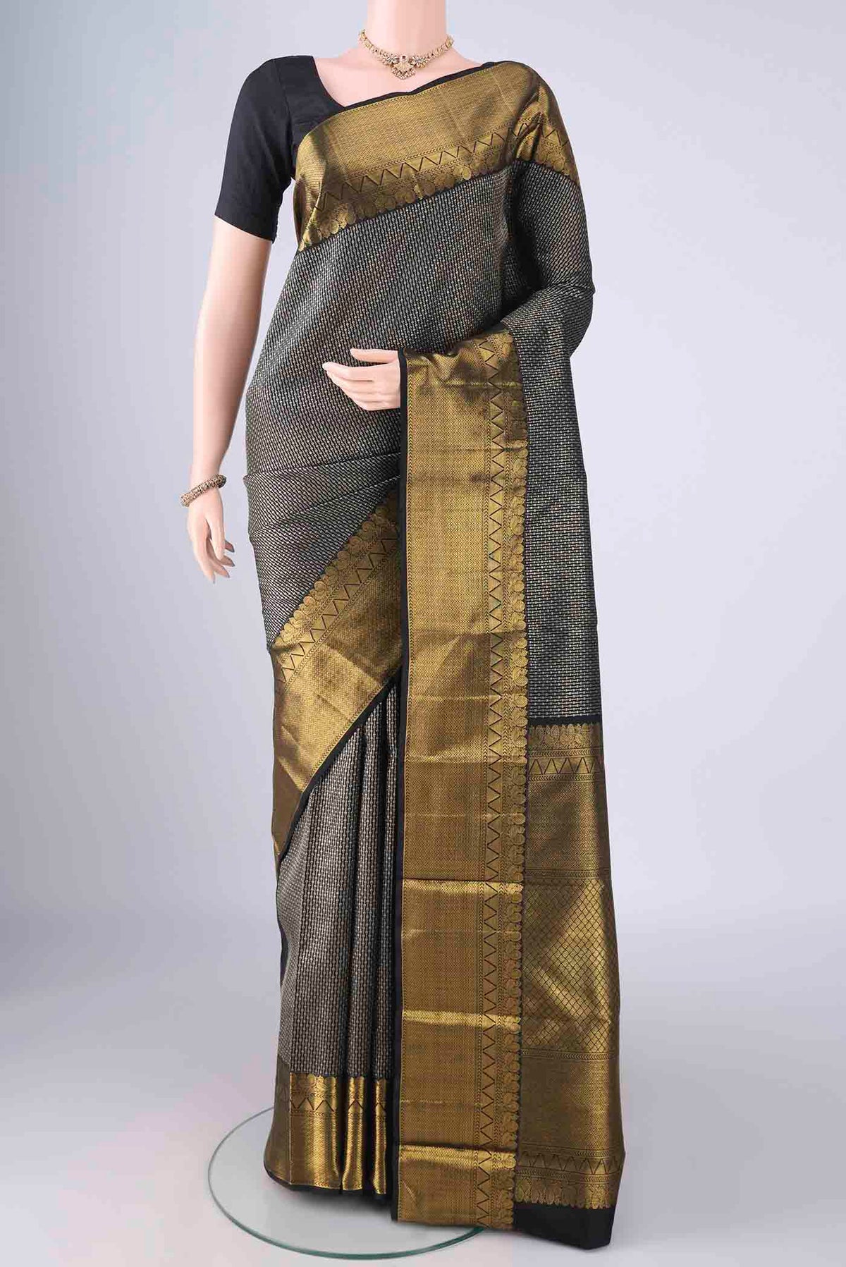 Black Kanchipuram Silk Saree with Zari Brocade on the body and Zari Border.  displayed on a mannequin