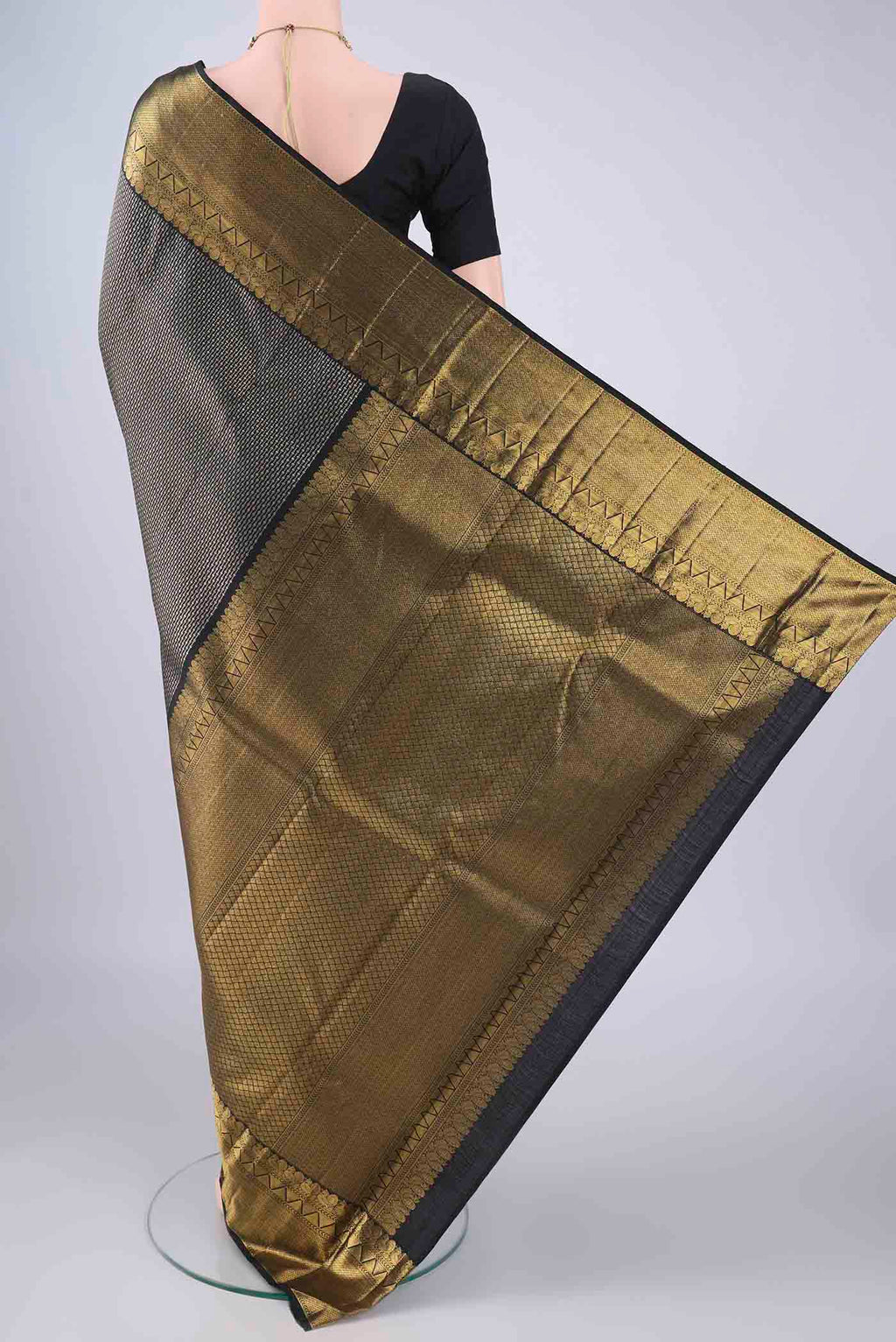 Flat view of Black Kanchipuram Silk Saree with Zari Brocade on the body and Zari Border. 