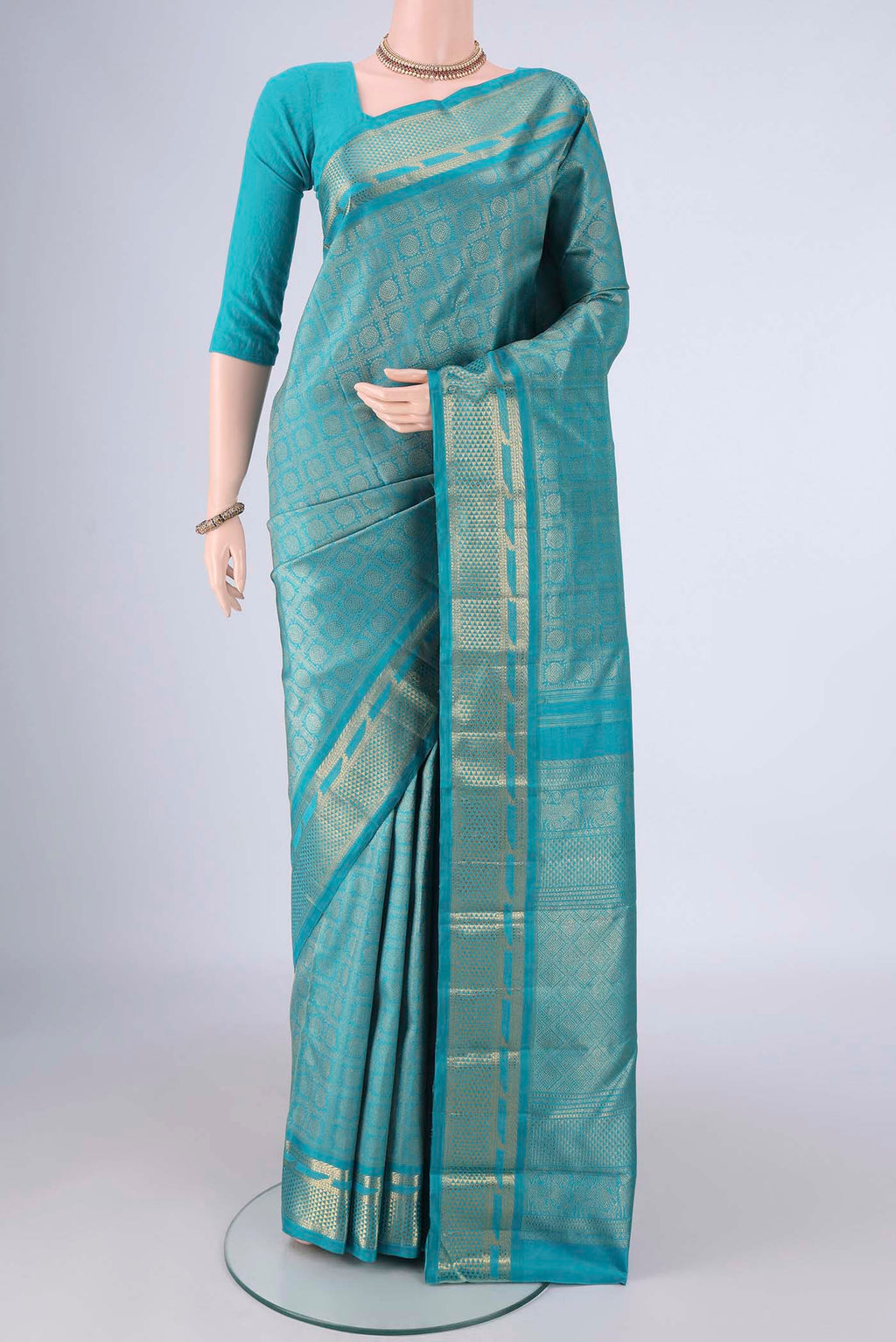 Pure Silk Pure Zari Sea Green Kanjivaram Saree with Zari Brocade on the body and Zari Border.  displayed on a mannequin