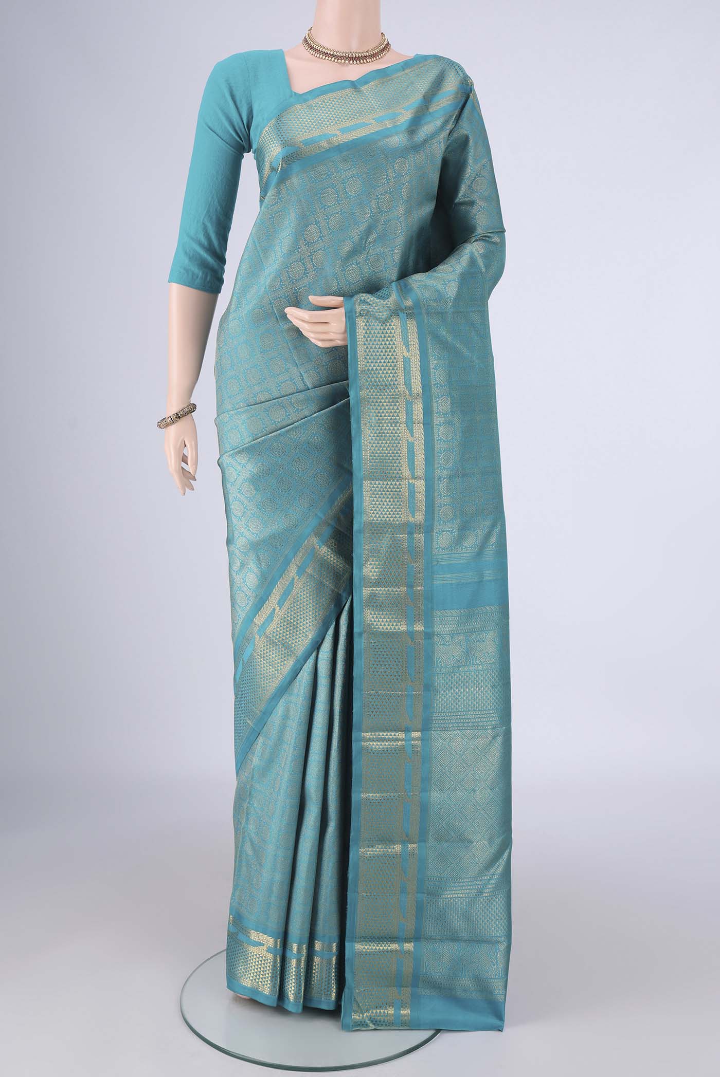 Pure Silk Pure Zari Sea Green Kanjivaram Saree with Zari Brocade on the body and Zari Border.  displayed on a mannequin