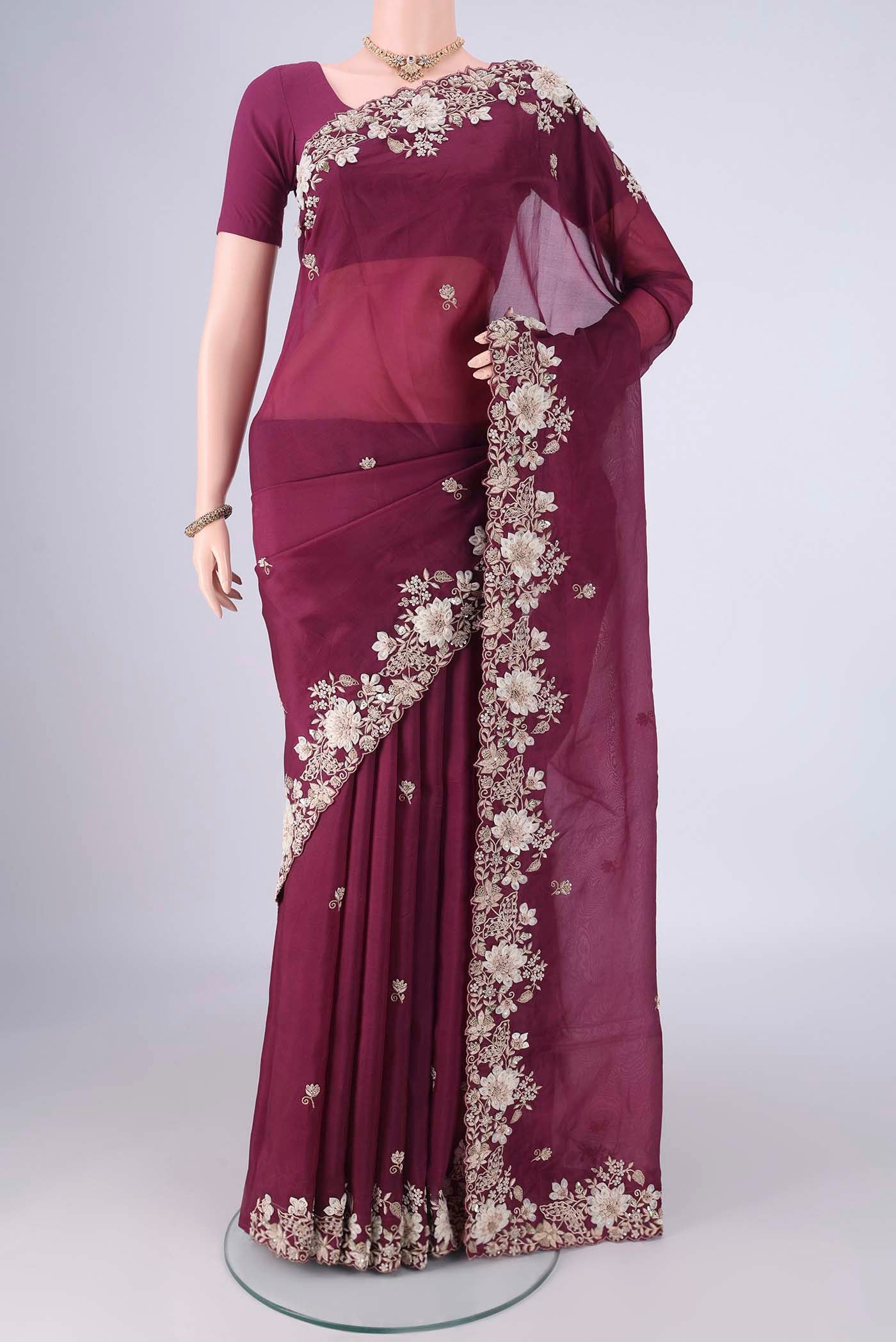 Burgundy Kanjivaram Silk Saree with Embroidery on the body and Embroidery Border.  displayed on a mannequin