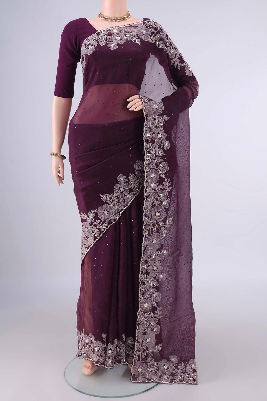 Burgundy Organza Saree with Embroidery on the body and Embroidery Border.  displayed on a mannequin