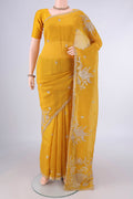 Mustard Organza Saree with Embroidery on the body and Embroidery Border.  displayed on a mannequin
