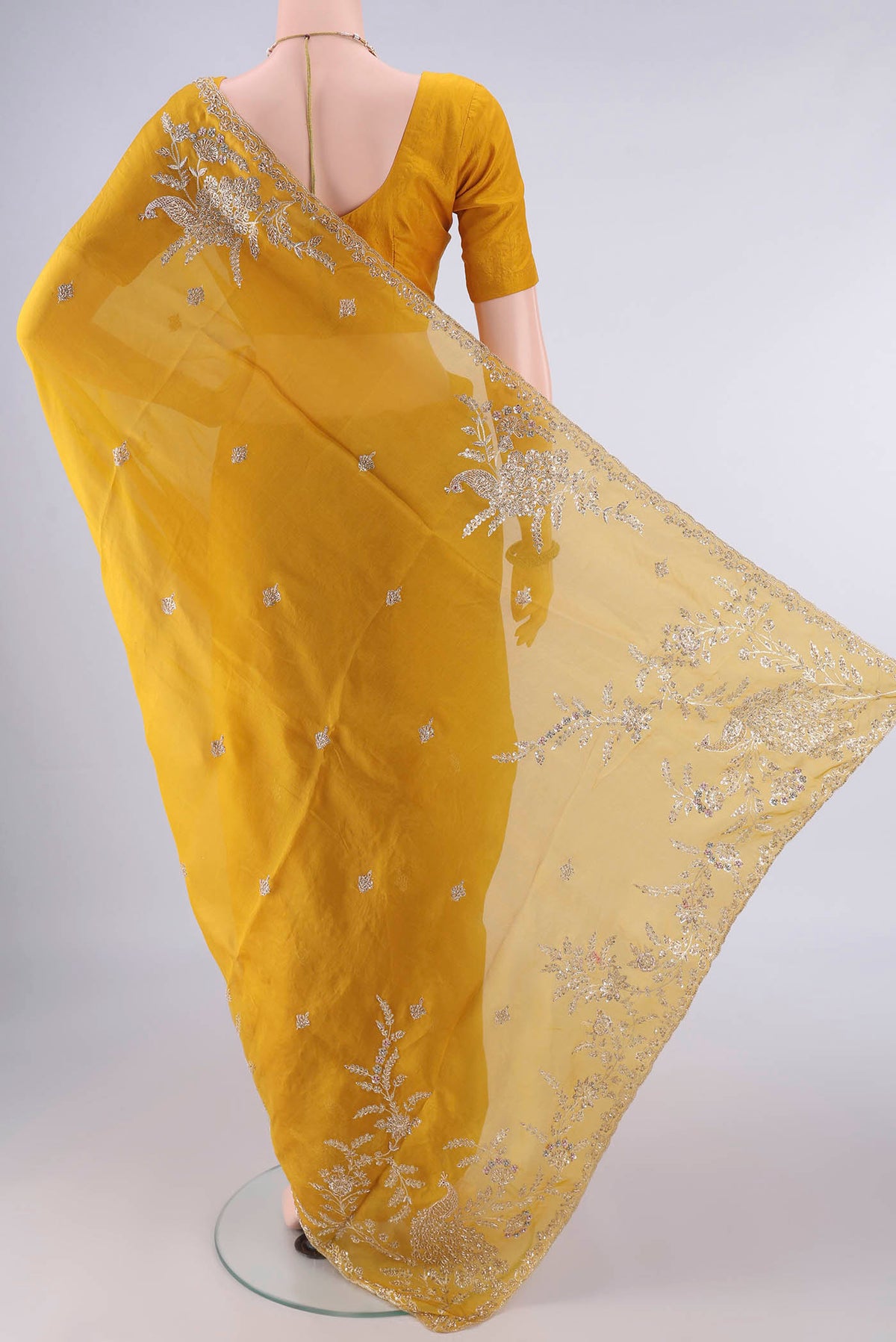 Flat view of Mustard Organza Saree with Embroidery on the body and Embroidery Border. 