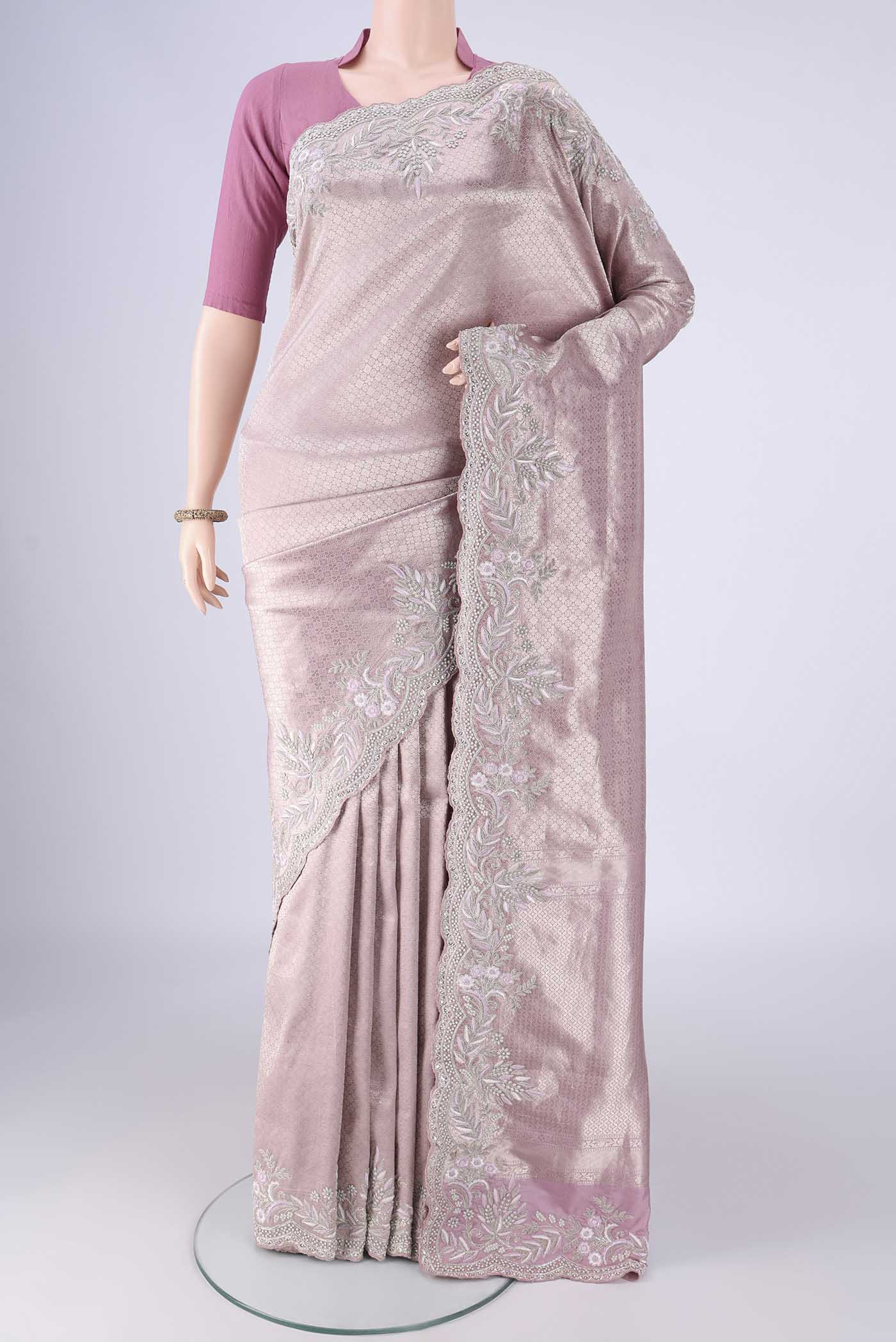 Rose pink Banarasi Silk Saree with Zari Brocade on the body and Embroidery Border.  displayed on a mannequin