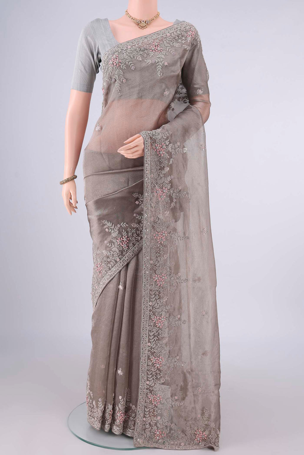 Davys Grey Organza Saree with Embroidery on the body and Embroidery Border.  displayed on a mannequin