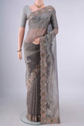 Grey Organza Saree with Embroidery on the body and Embroidery Border.  displayed on a mannequin