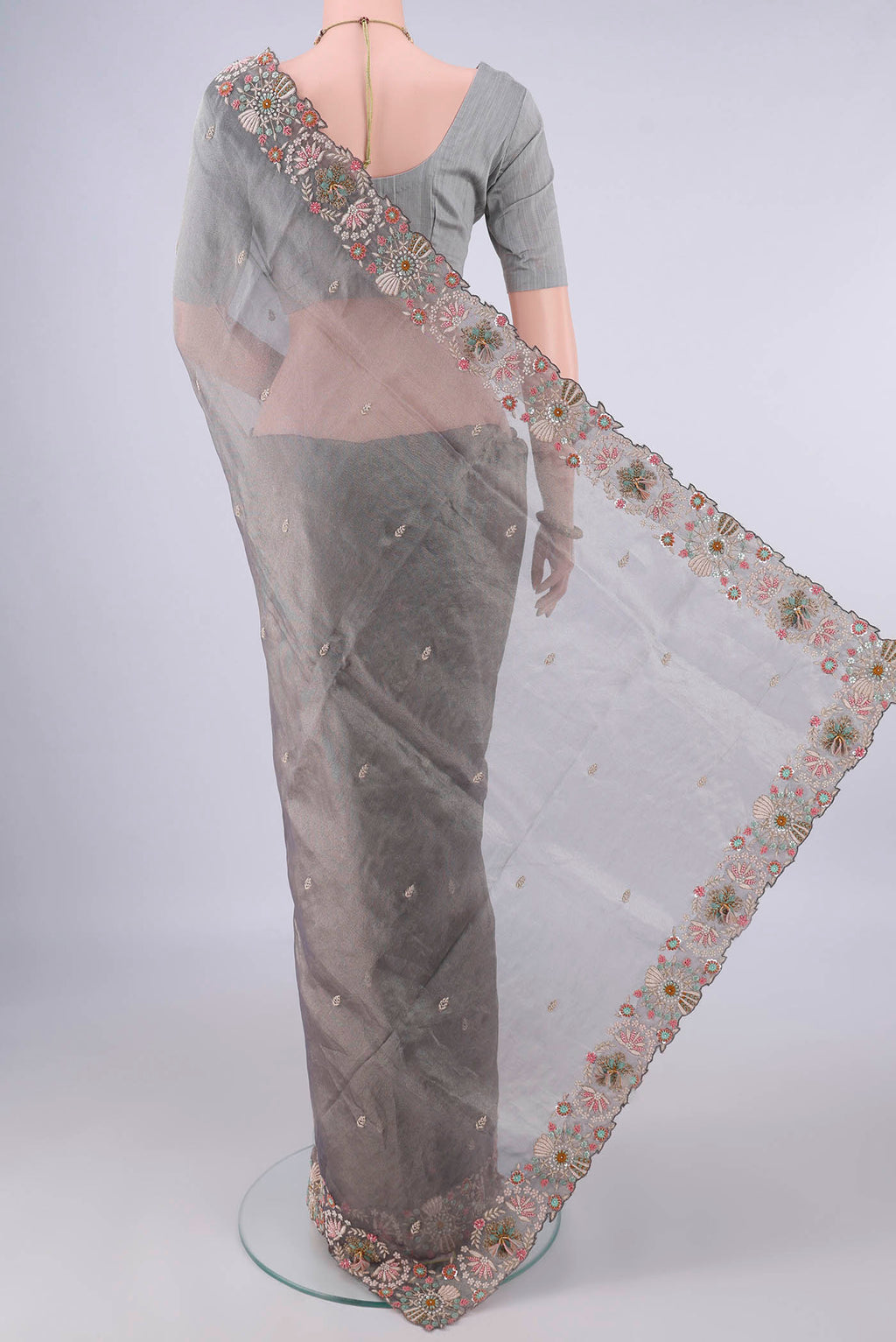 Flat view of Grey Organza Saree with Embroidery on the body and Embroidery Border. 