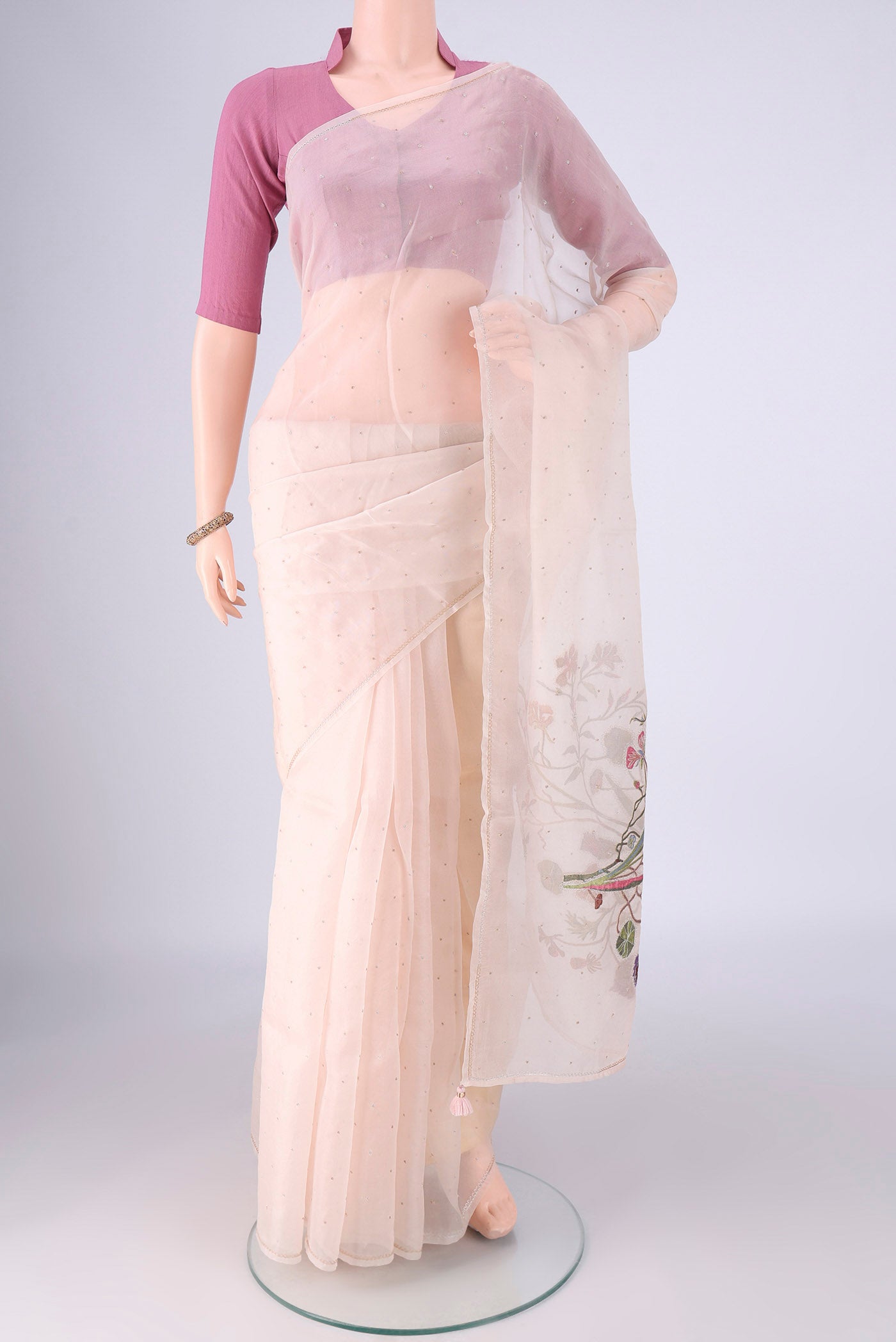 Beige Kanjivaram Silk Saree with Embroidery on the body and Zari Border.  displayed on a mannequin