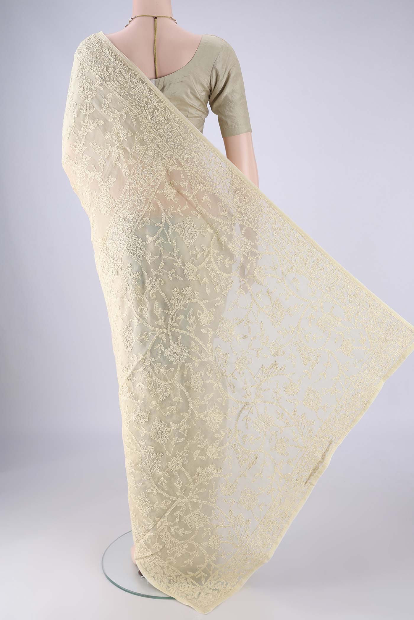 Flat view of Beige Organza Silk Saree with Embroidery on the body and Thread Border. 