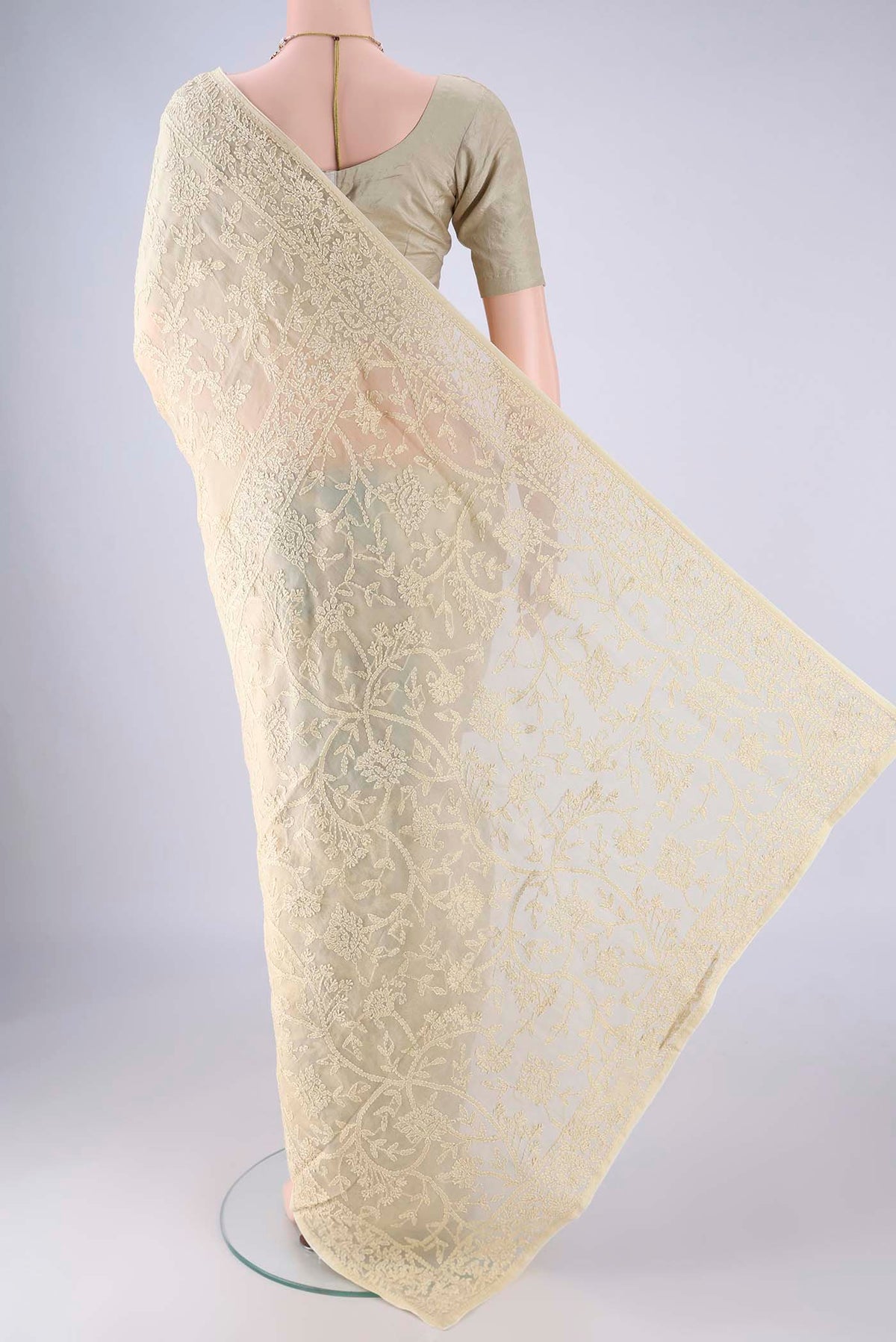Flat view of Beige Organza Silk Saree with Embroidery on the body and Thread Border. 