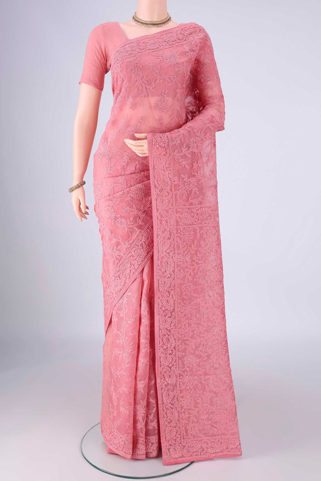 Pink Organza Silk Saree with Embroidery on the body and Embroidery Border.  displayed on a mannequin