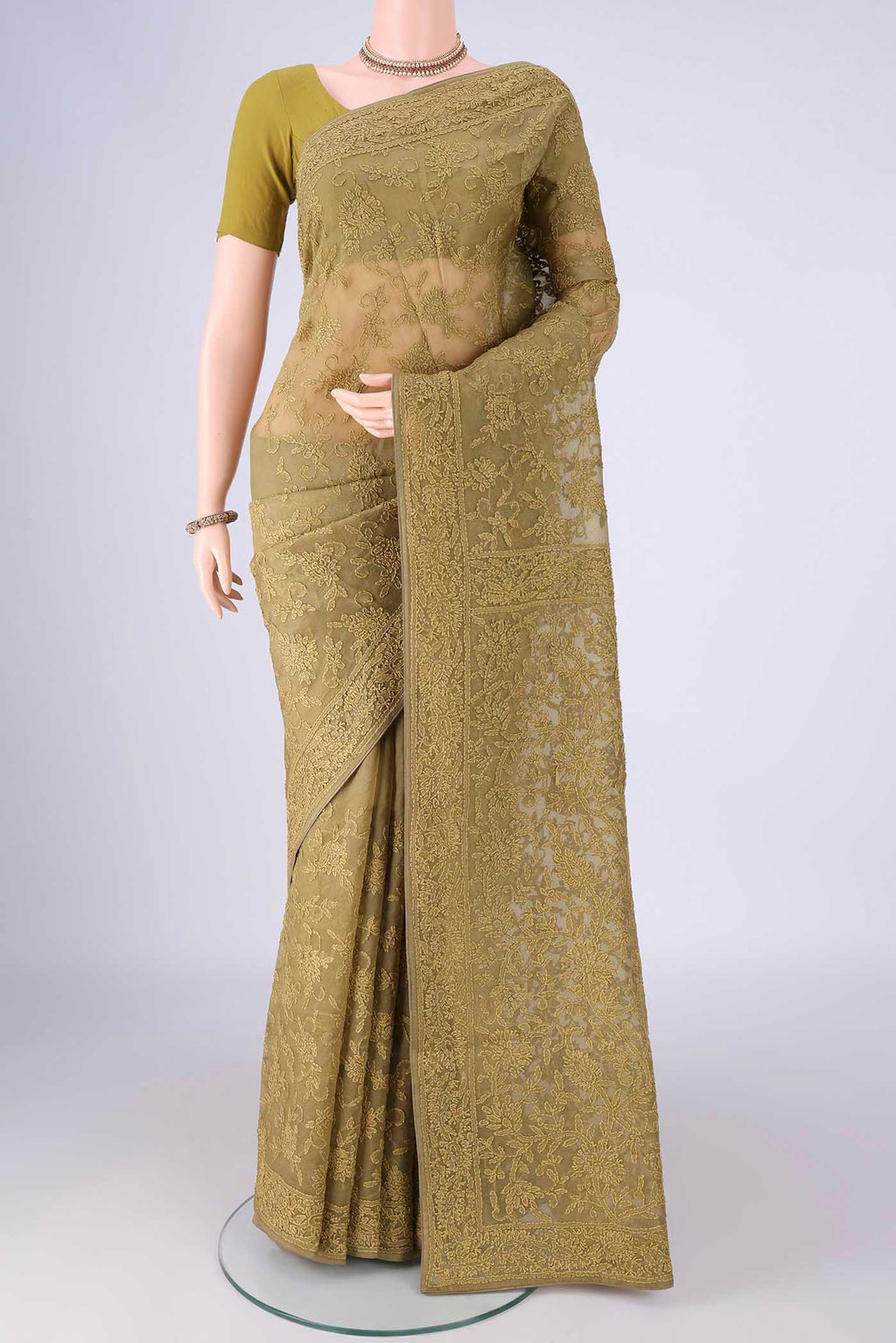 Mehandi Green Organza Silk Saree with Embroidery on the body and Embroidery Border.  displayed on a mannequin