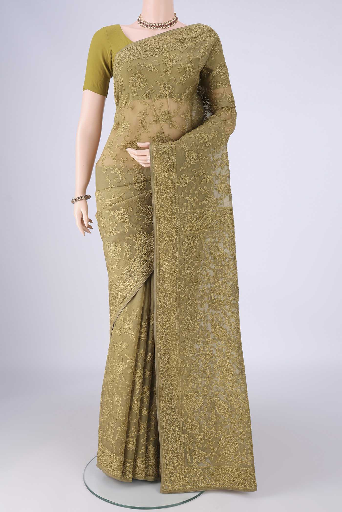Mehandi Green Organza Silk Saree with Embroidery on the body and Embroidery Border.  displayed on a mannequin