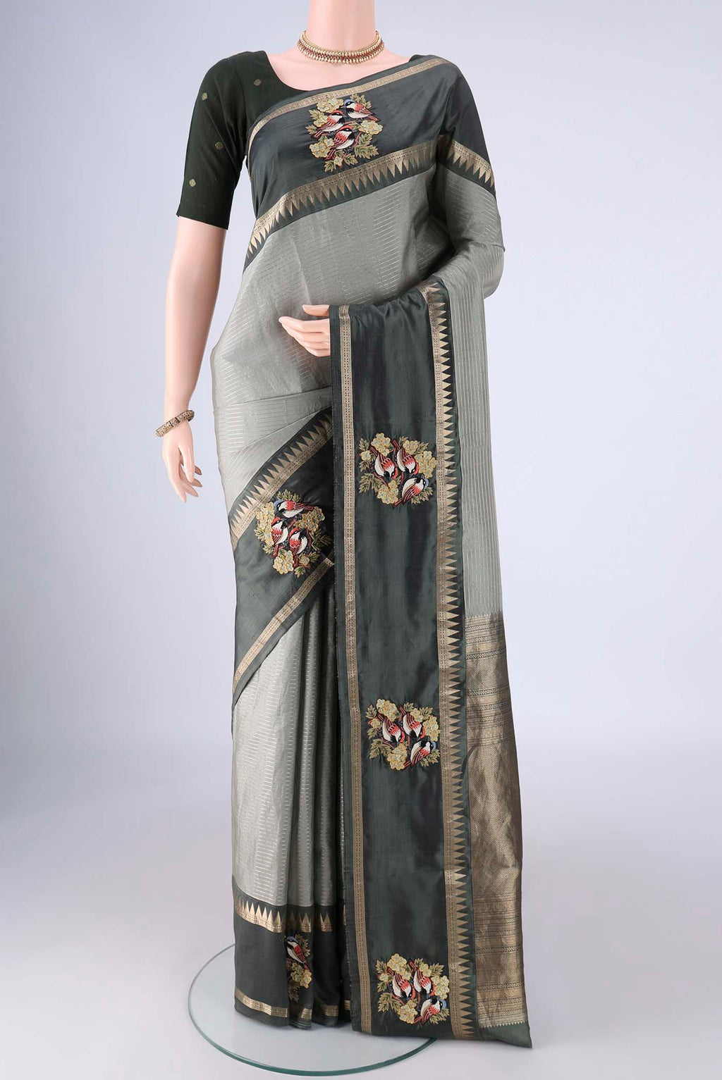 Grey Kanchipuram Silk Saree with Stripes on the body and Zari Border.  displayed on a mannequin