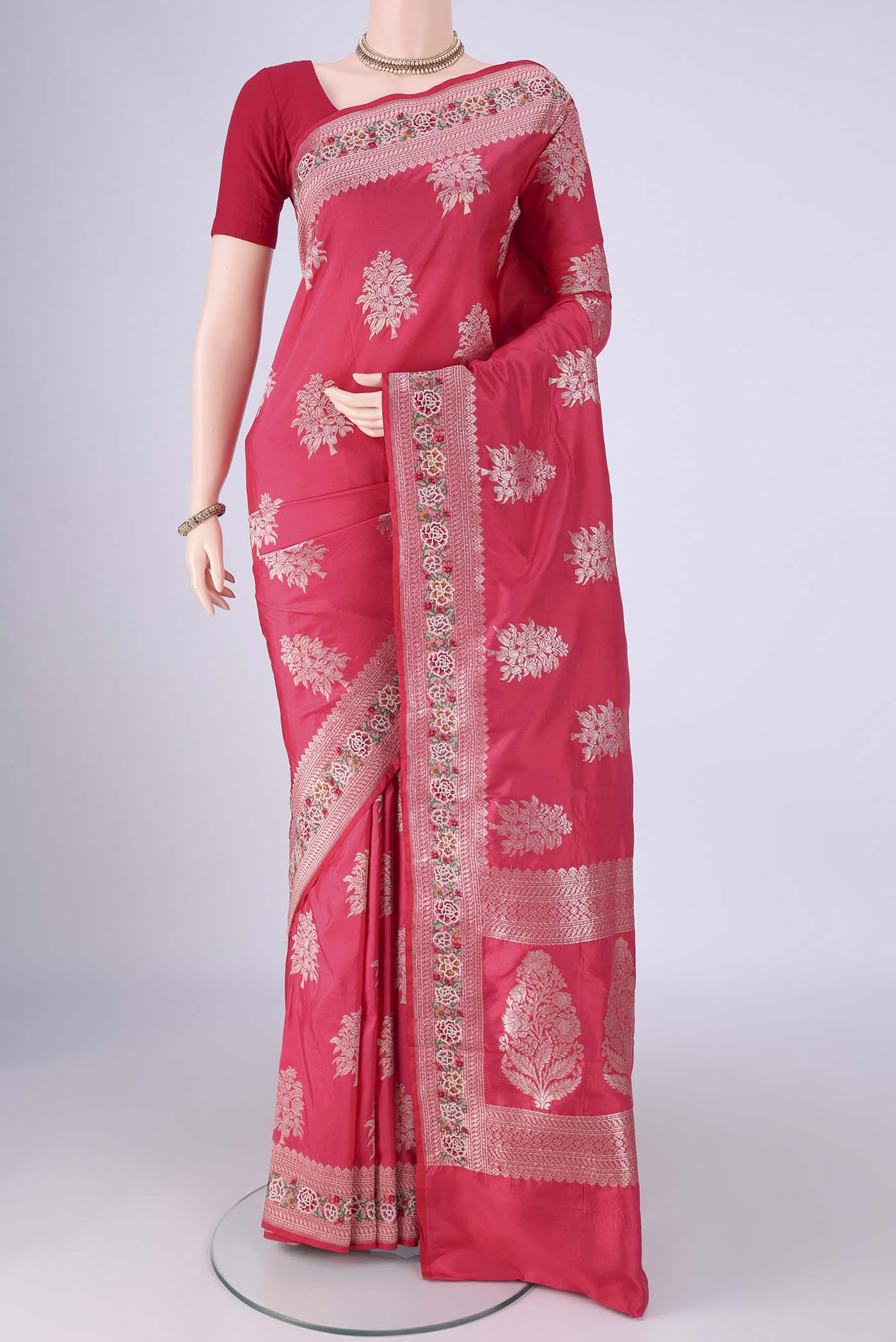 Imperial Pink Banarasi Silk Saree with Zari Butta on the body and Zari Border.  displayed on a mannequin