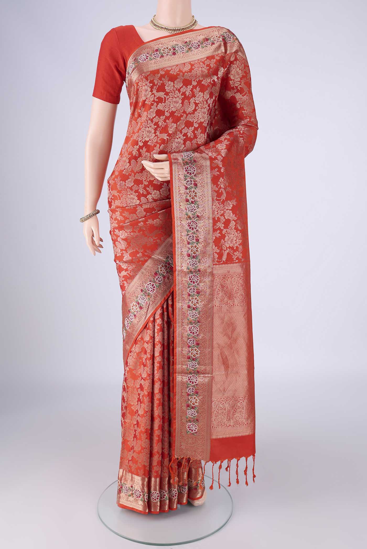 Orange Banarasi Silk Saree with Zari Brocade on the body and Zari Border.  displayed on a mannequin