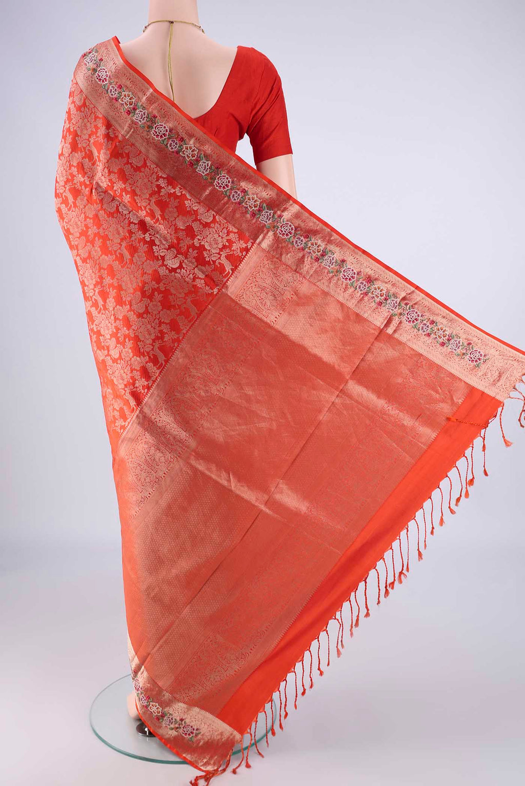 Flat view of Orange Banarasi Silk Saree with Zari Brocade on the body and Zari Border. 