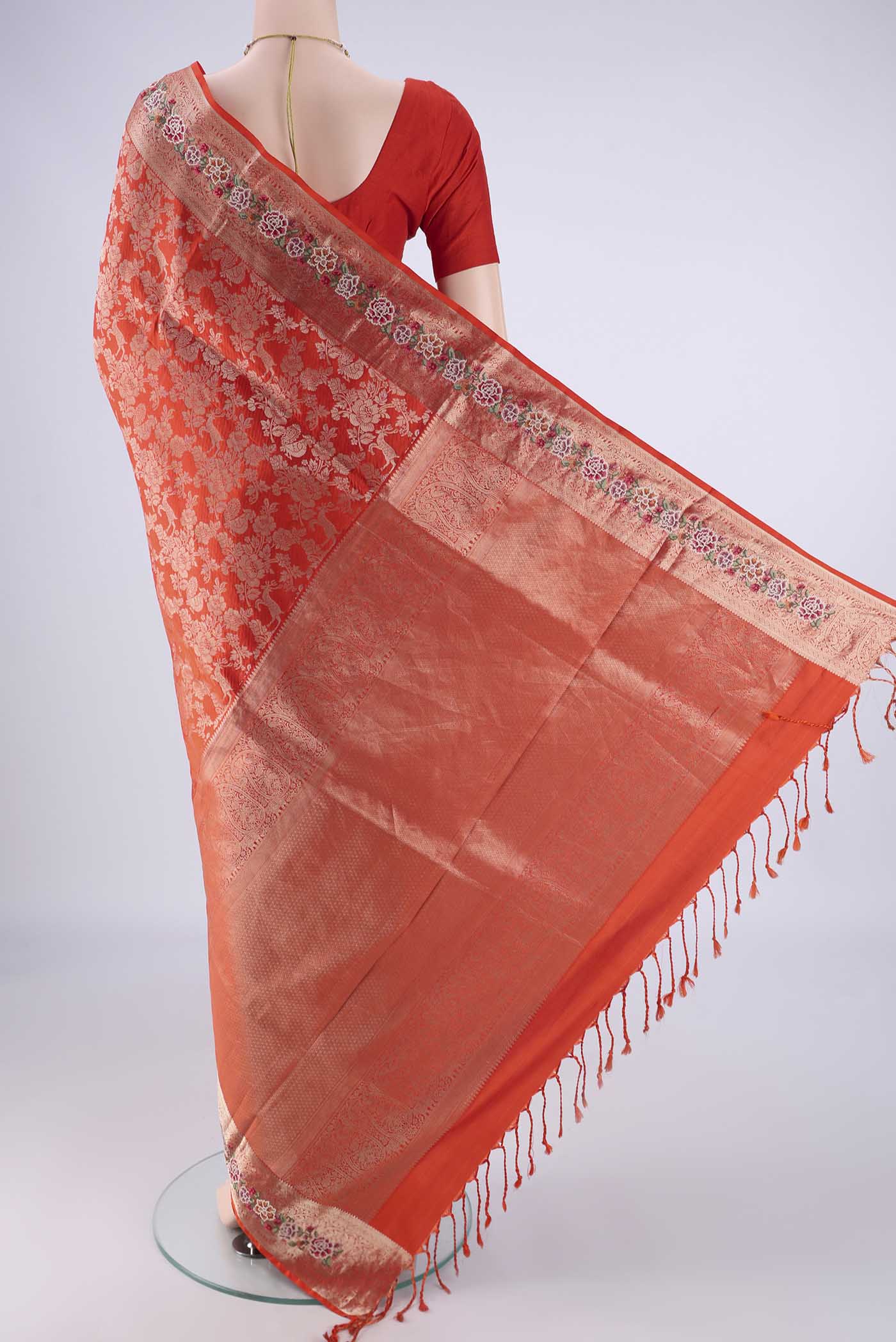 Flat view of Orange Banarasi Silk Saree with Zari Brocade on the body and Zari Border. 