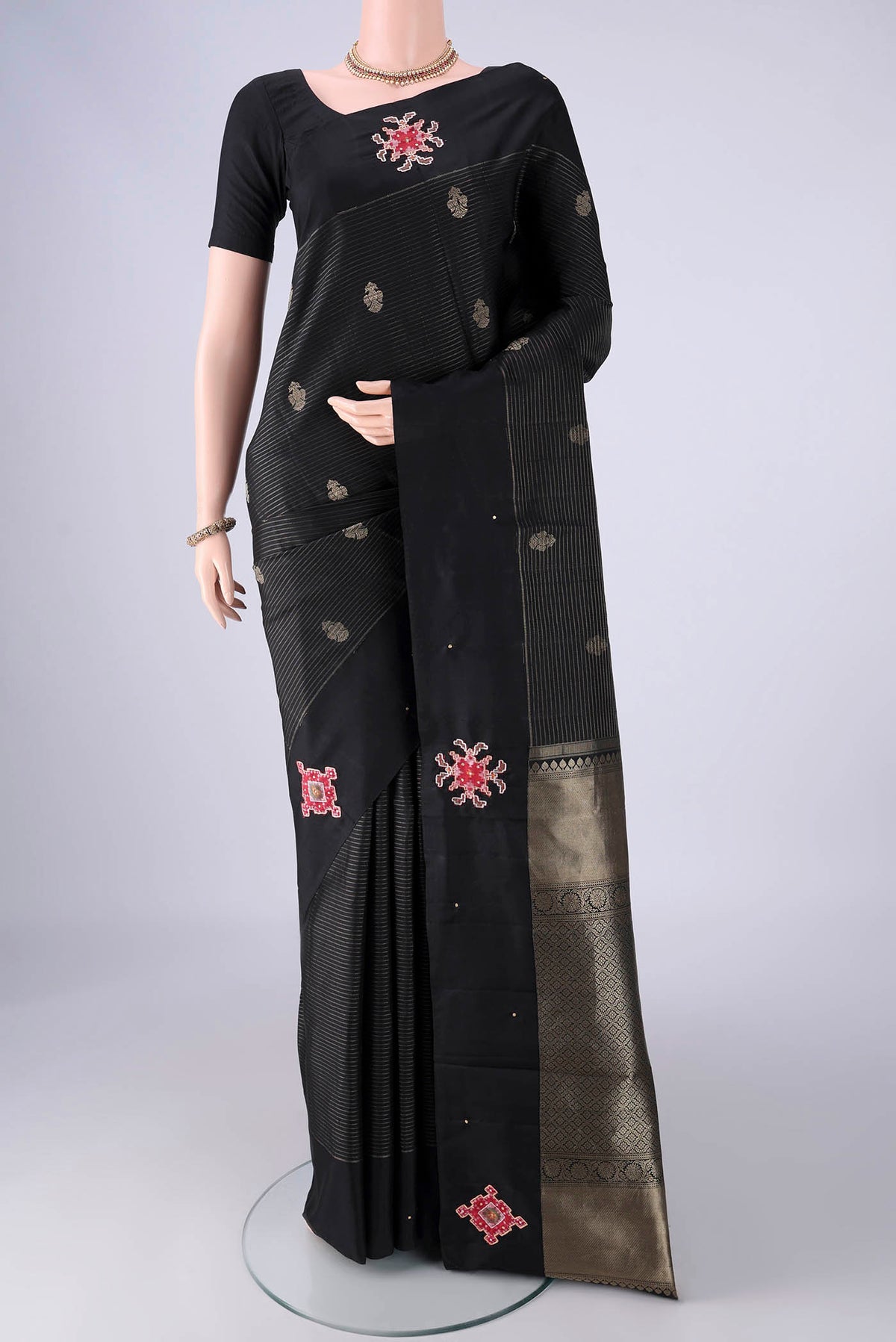 Black Kanchipuram Silk Saree with Stripes on the body and Plain Border.  displayed on a mannequin