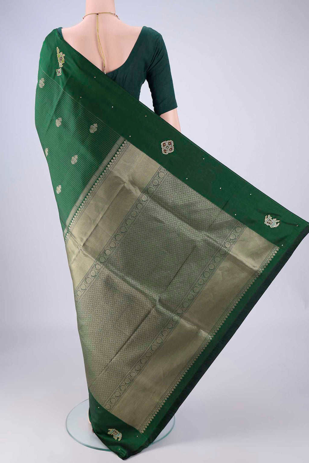 Flat view of Green Kanchipuram Silk Saree with Zari Butta on the body and Zari Border. 