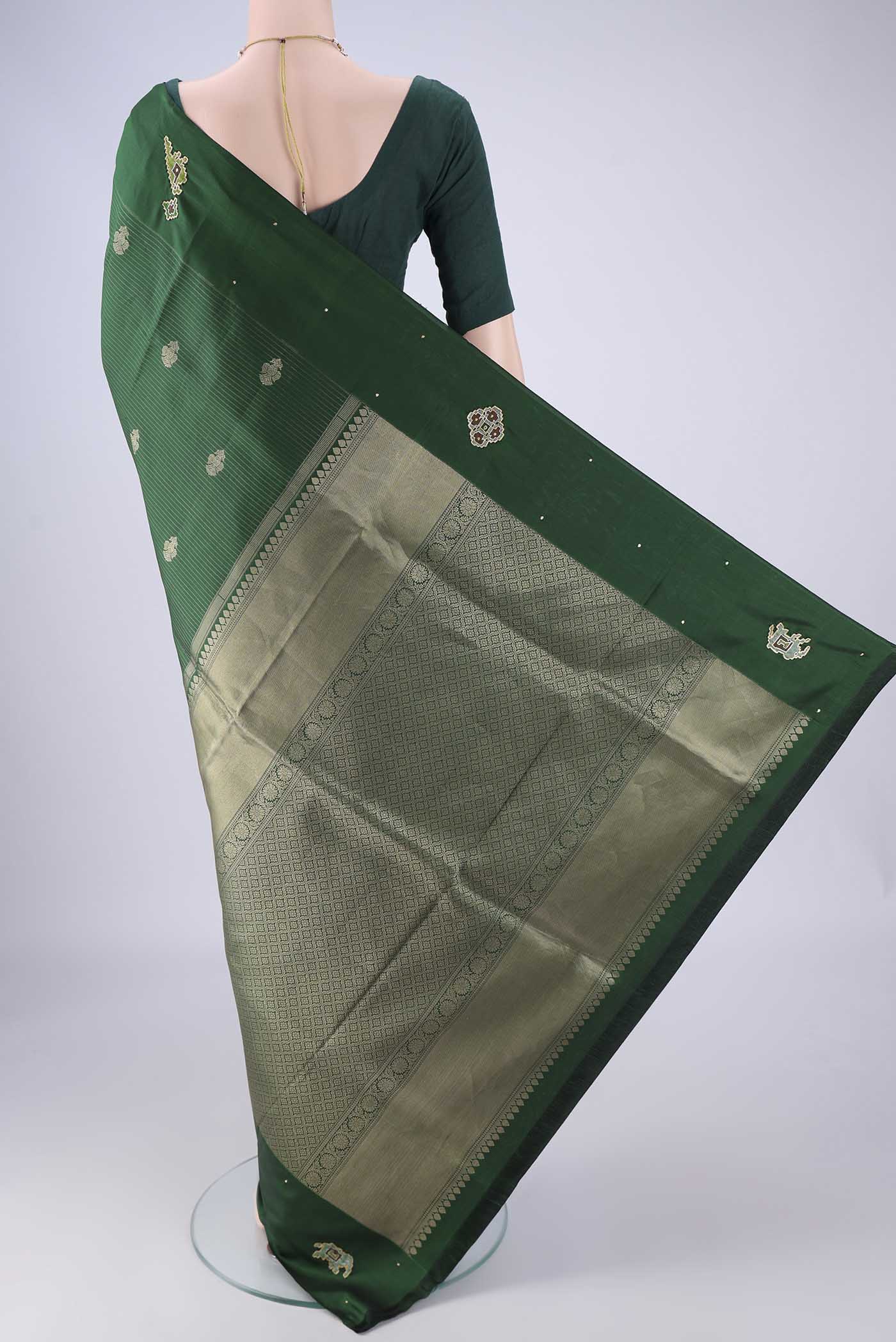 Flat view of Green Kanchipuram Silk Saree with Zari Butta on the body and Zari Border. 
