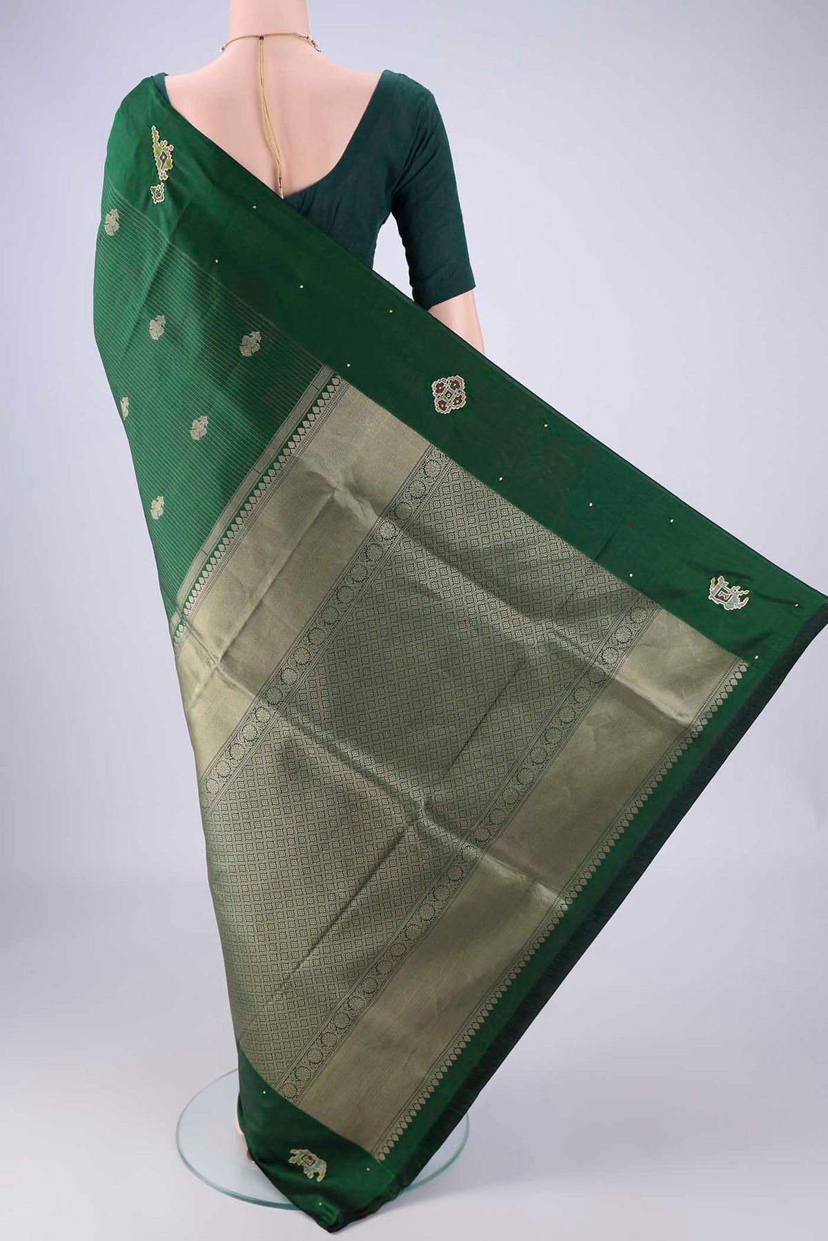 Flat view of Green Kanchipuram Silk Saree with Zari Butta on the body and Zari Border. 